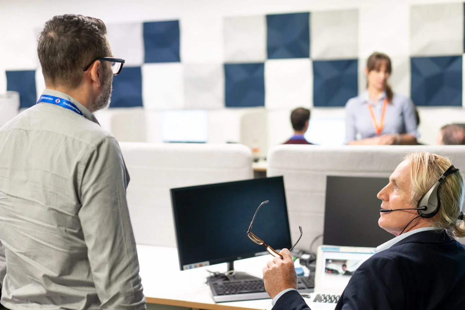 A commercial image of a 2 men sitting in front of a computer in an office, taken by commercial photographer Tom MacDonald of Tom Mac photography