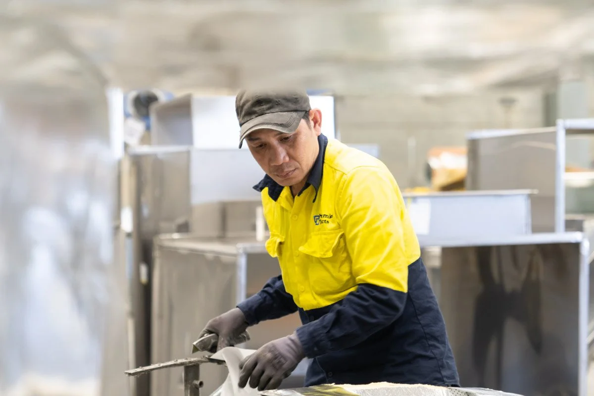 A commercial photograph of an industrial worker in a Brisbane metal fabrication workshop, taken by commercial photographer Tom MacDonald of Tom Mac photography