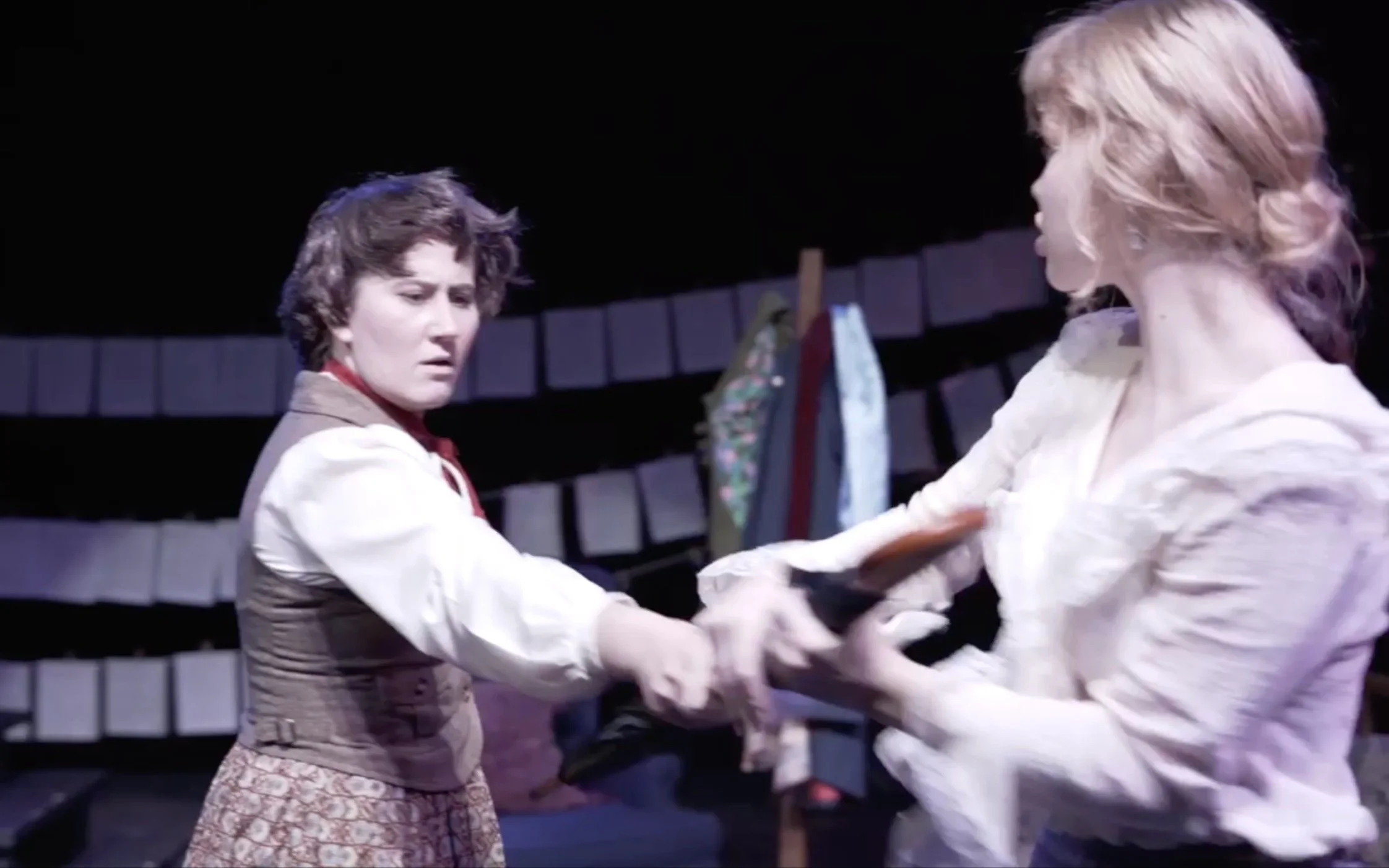Meg and Jo fight over an umbrella.