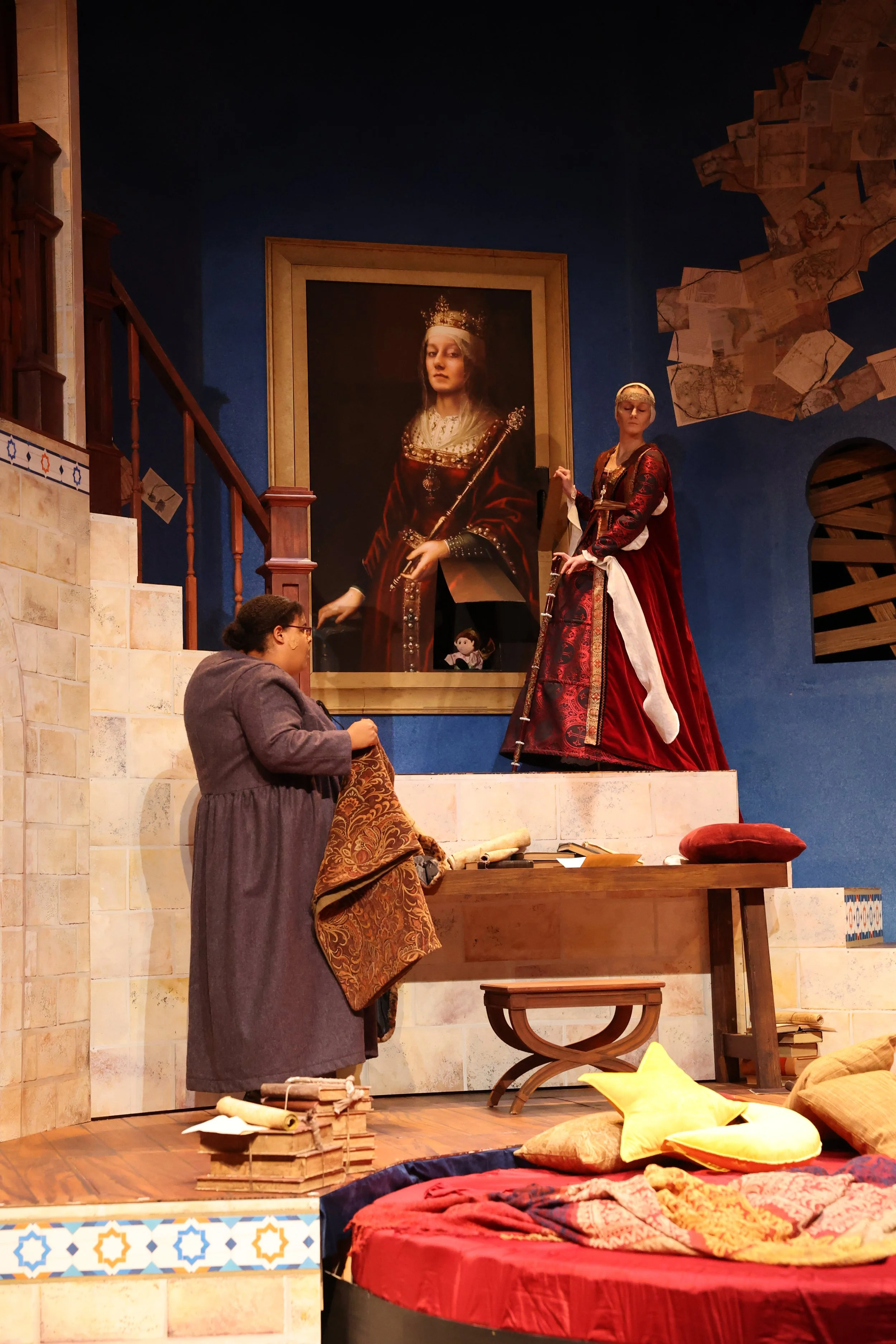 Queen Isabella reveals Infanta Juana's doll hidden in the painting. 