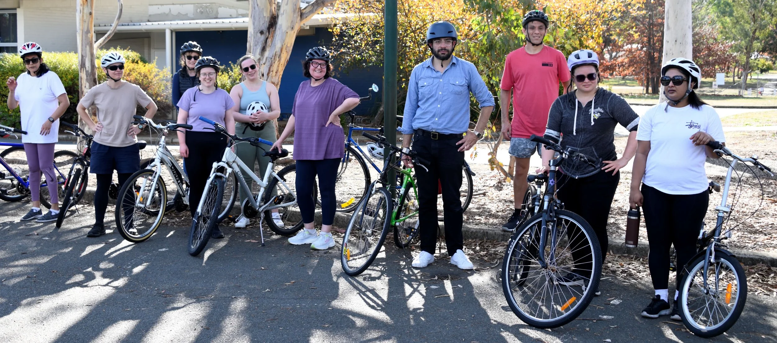 A group of Cycle Well participants standing with their bikes after a course session