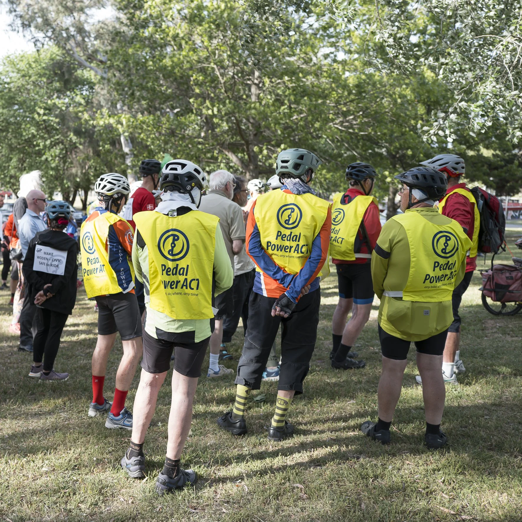 Pedal Power supporters gathered in Woden for the campaign ride, including a sign calling for a safe Woden to Civic route