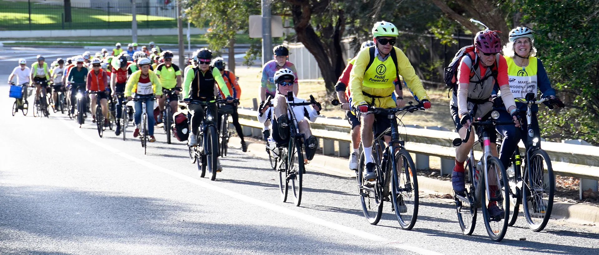 Pedal Power cyclists riding together in a large group on a Canberra road