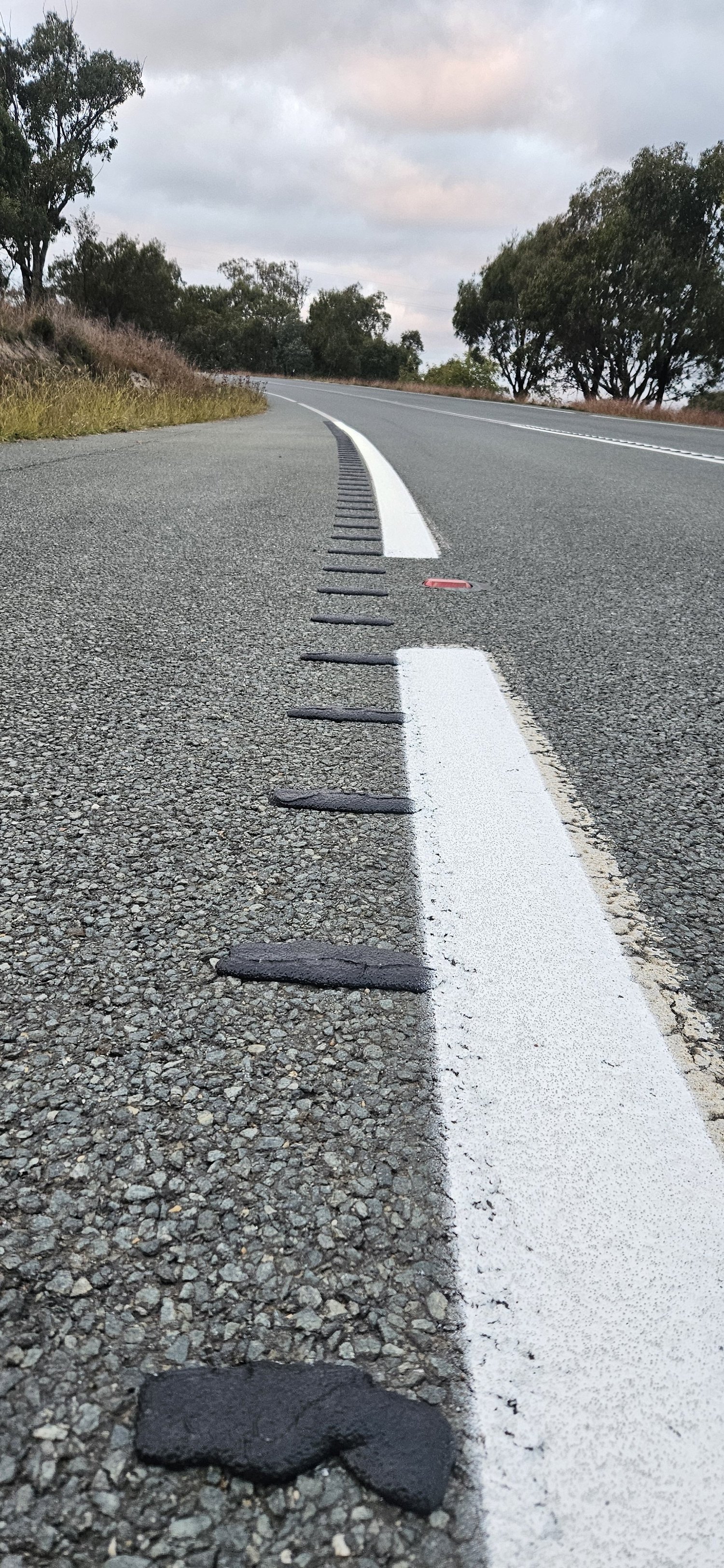 Rumble strips beside the narrow shoulder on Cotter Road