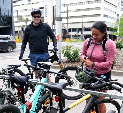 Two riders standing beside their bikes at the 2026 Ride2Work breakfast