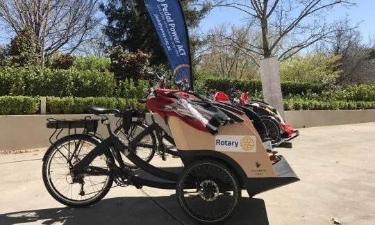 A Rotary-supported Cycling Without Age trishaw parked and ready for passengers