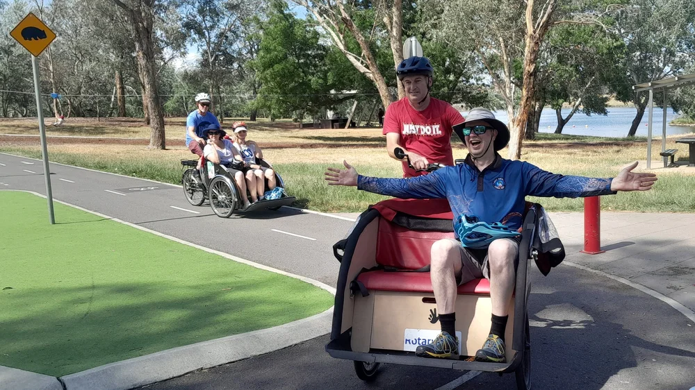 A Cycling Without Age volunteer learning to pilot a trishaw