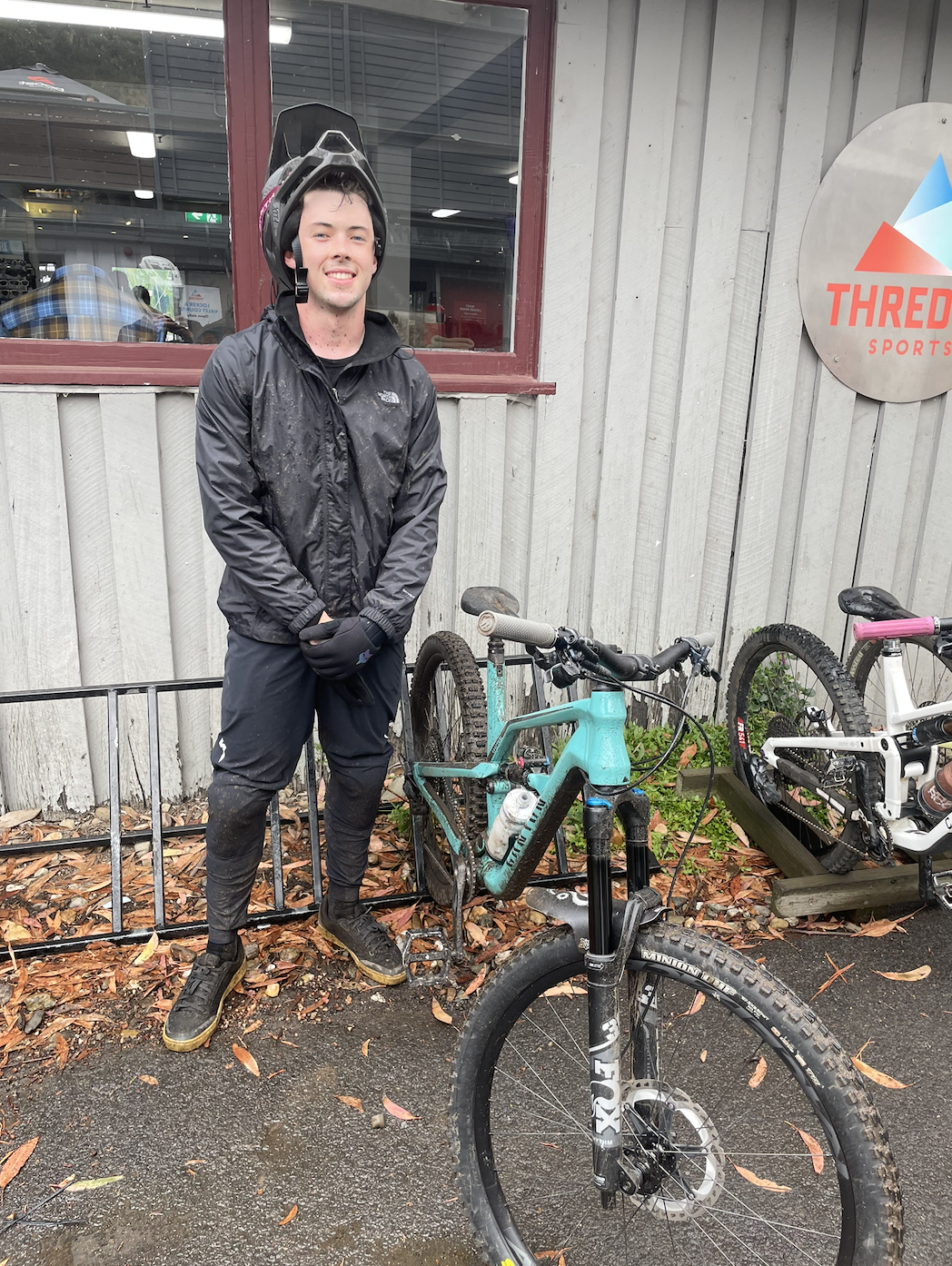 Pedal Power member Liam standing beside his mountain bike at Thredbo