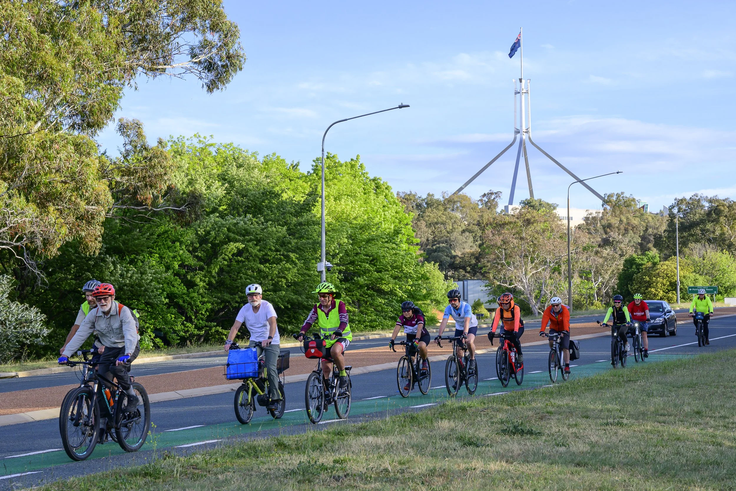 A group of Pedal Power riders cycling together in Canberra