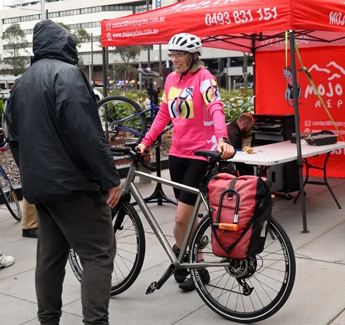 Two attendees chatting beside a bike at the 2026 Ride2Work event