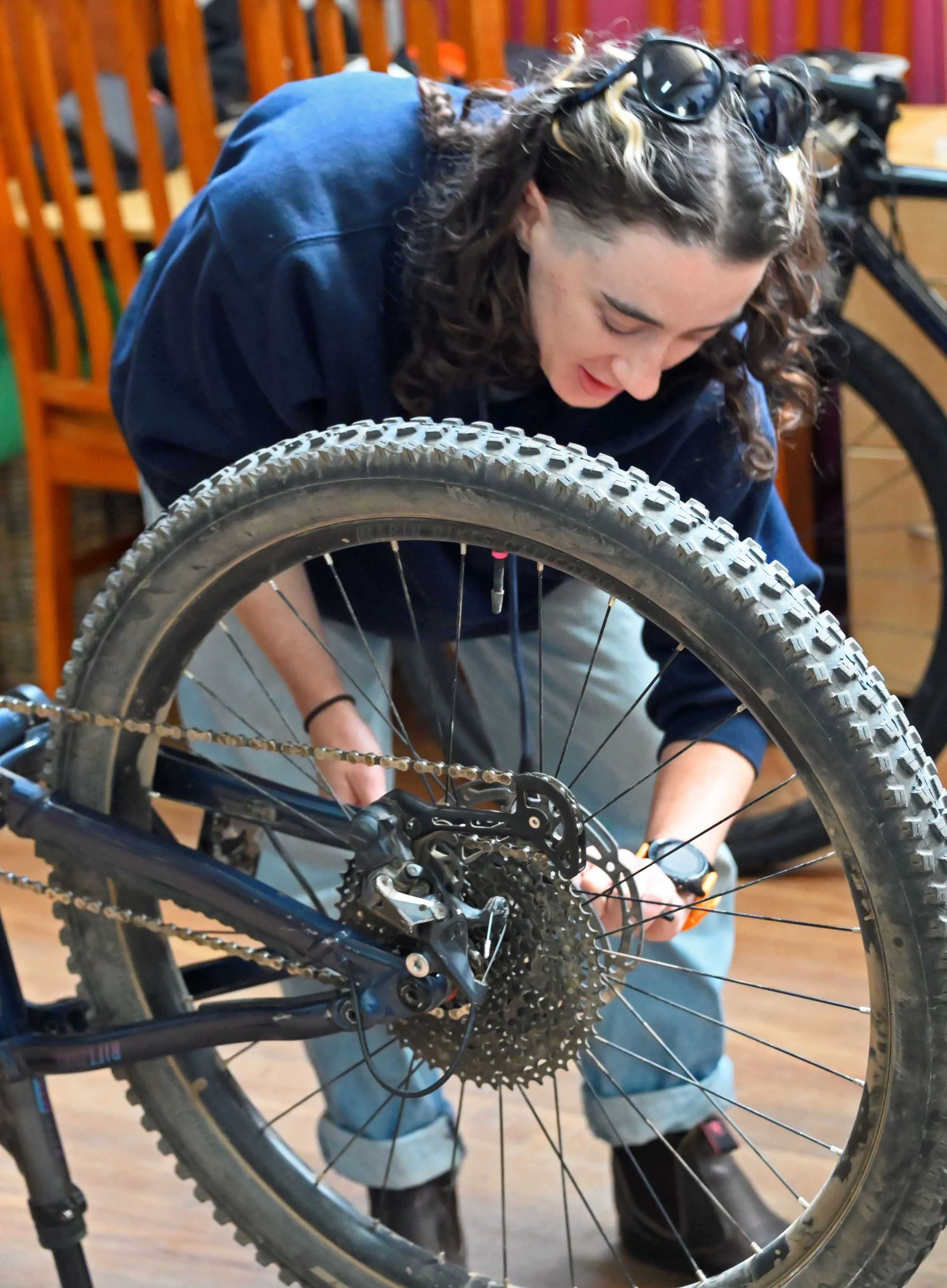 Participants learning practical bike maintenance at a Pedal Power workshop