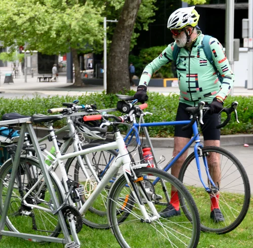 A rider in a green jersey beside a blue bike at Ride2Work Day 2026