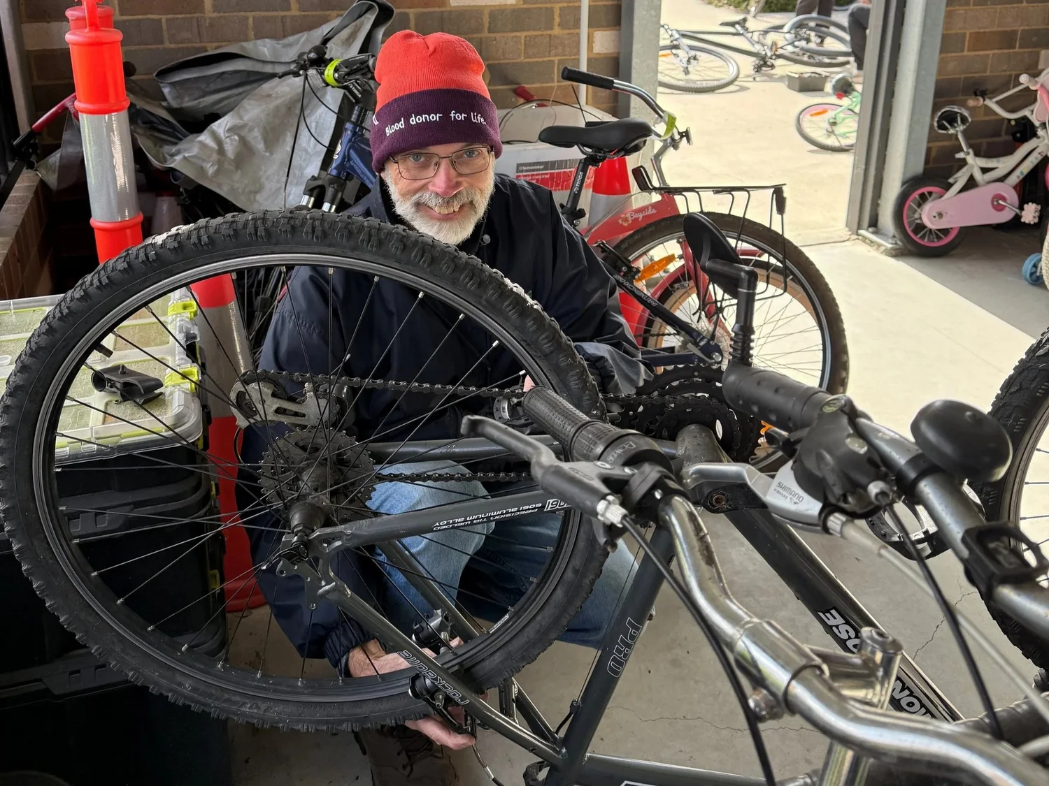 A Bike Library volunteer mechanic working on a bicycle