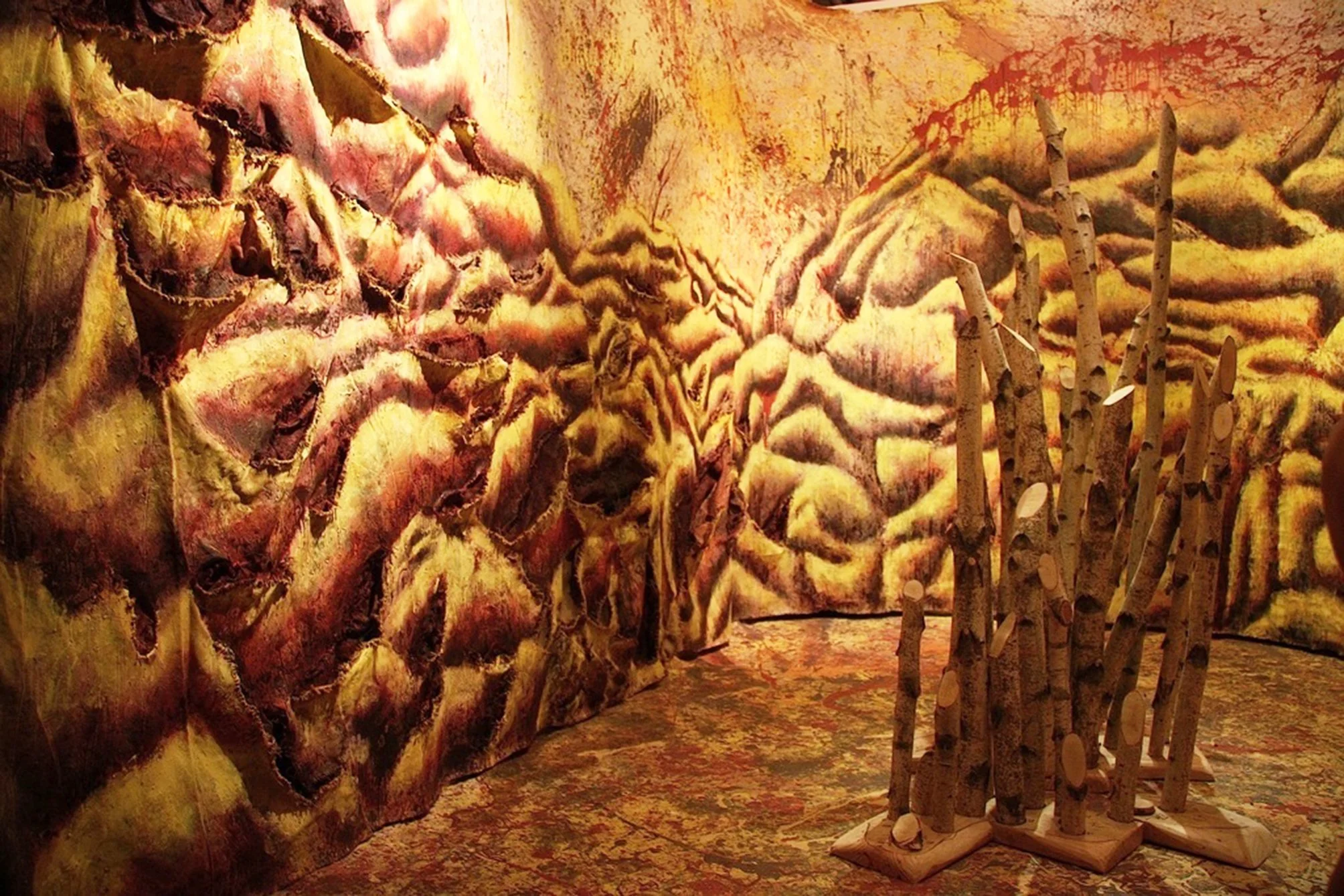 Karuna Painting, canvas, acrylic, house- and oil- paint, cord, burlap, birchtrees, pinewood, tracing paper, text  4 x 3 x 3 meters 2011