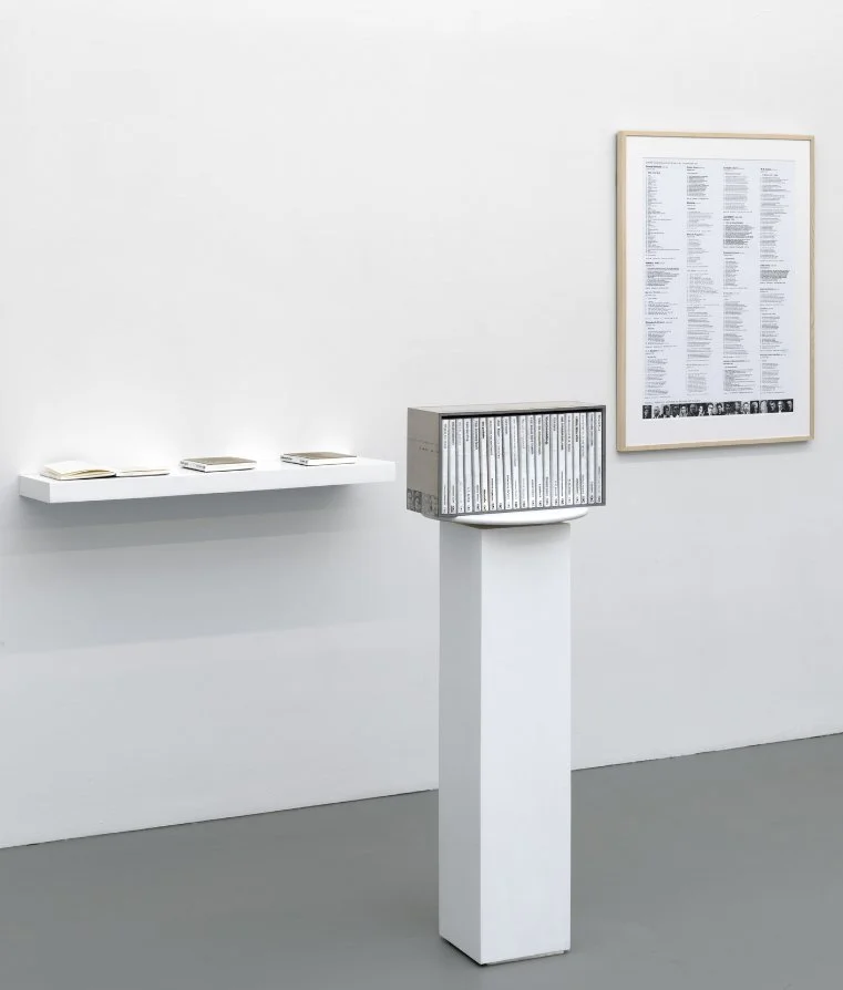 Poetry Account Balance, 2020 Hand stamped books in casing, pedestral, framed print 48 4/5 × 16 9/10 × 14 1/5 in | 124 × 43 × 36 cm