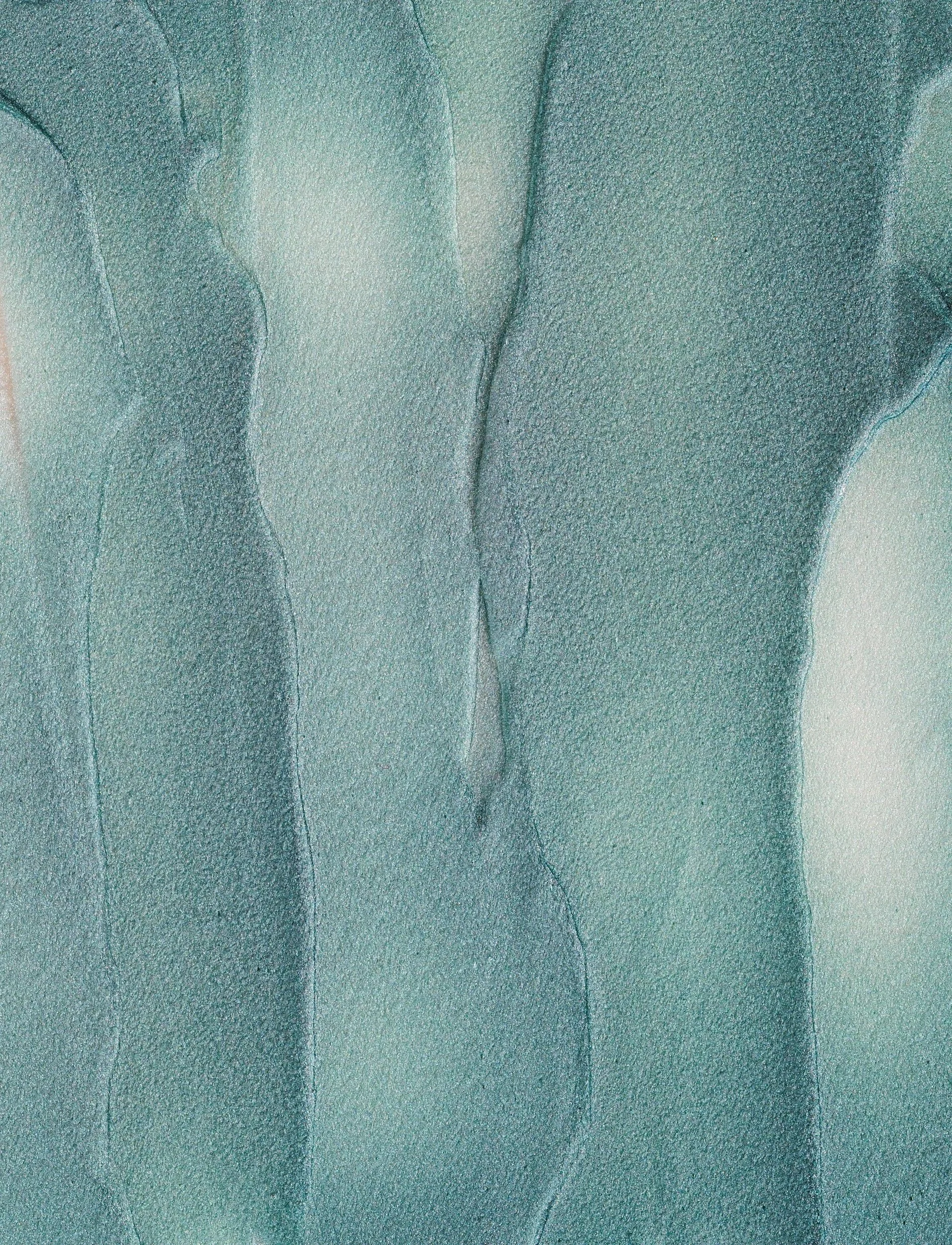 Close-up of green watercolor painting with abstract wavy shapes.