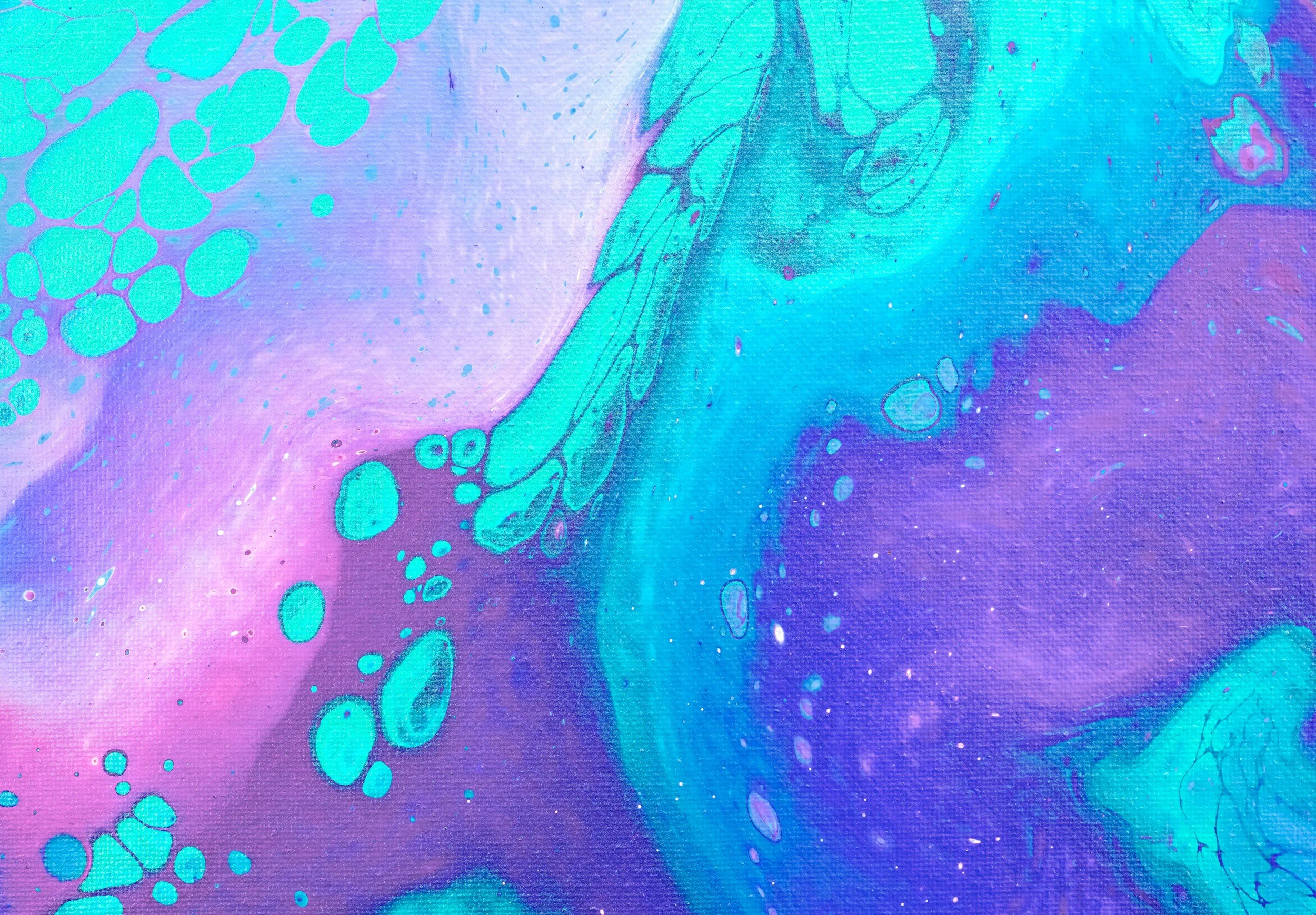 Abstract background with vibrant purple, blue, and teal hues, featuring swirling patterns and scattered bubble-like shapes.