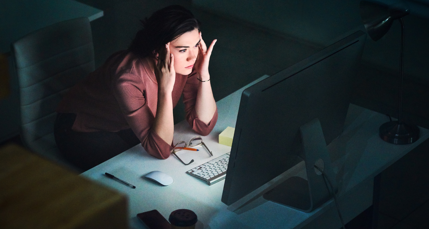 Woman staring at laptop in the dark