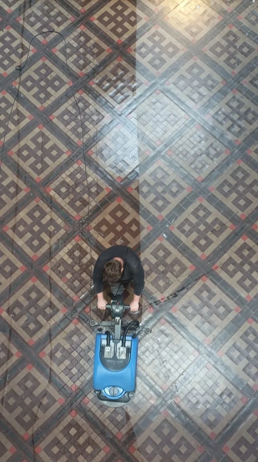 Kevan using industry equipment on Minton floor tiles Birmingham Museum.
