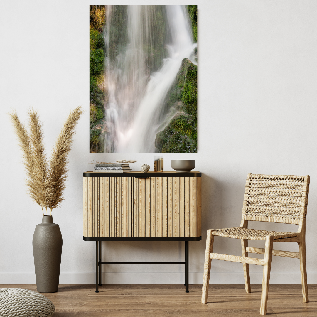 Serene waterfall artwork shown hanging in a living space.