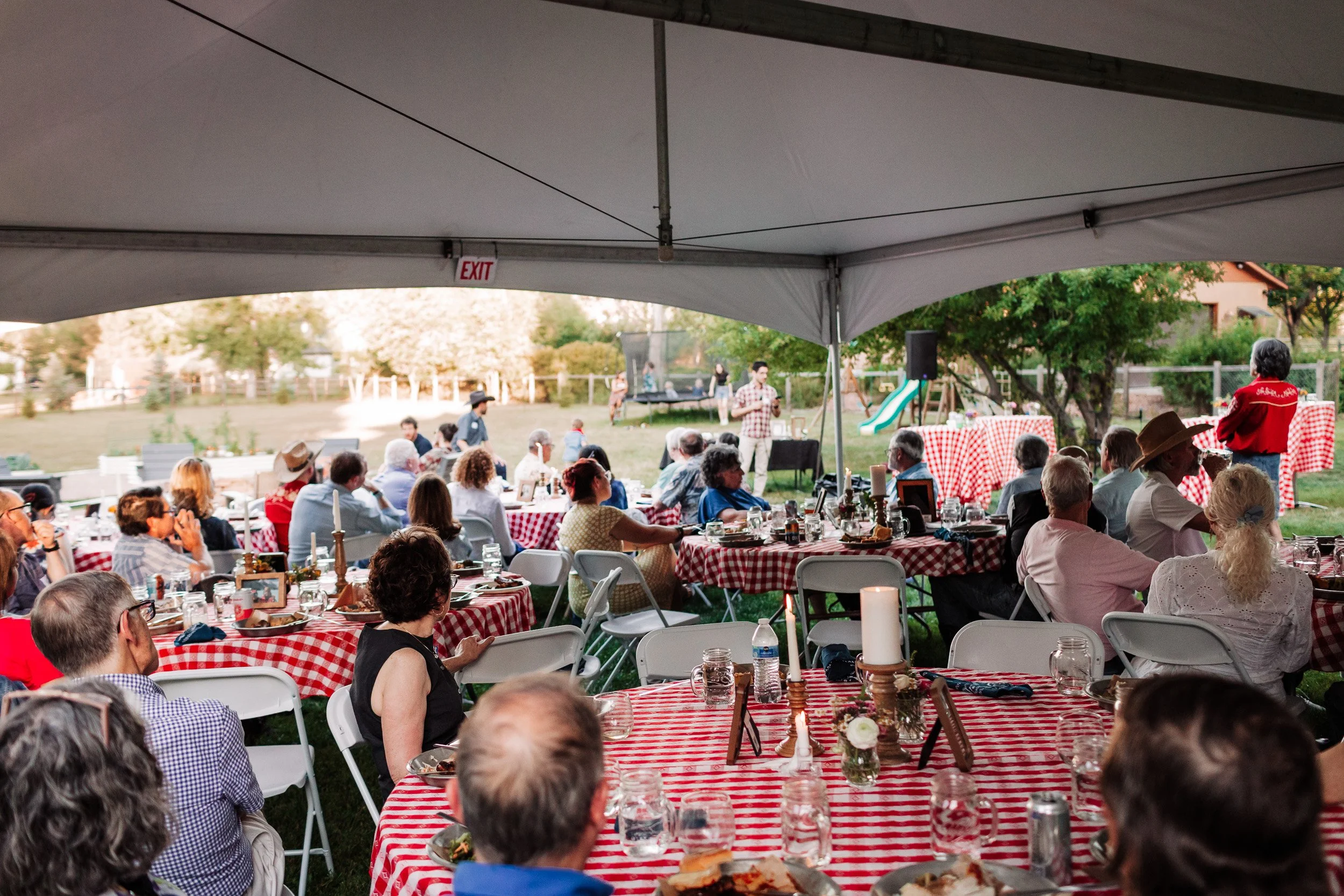Friends giving speeches about Nanette and Mike’s 50-year marriage during dinner