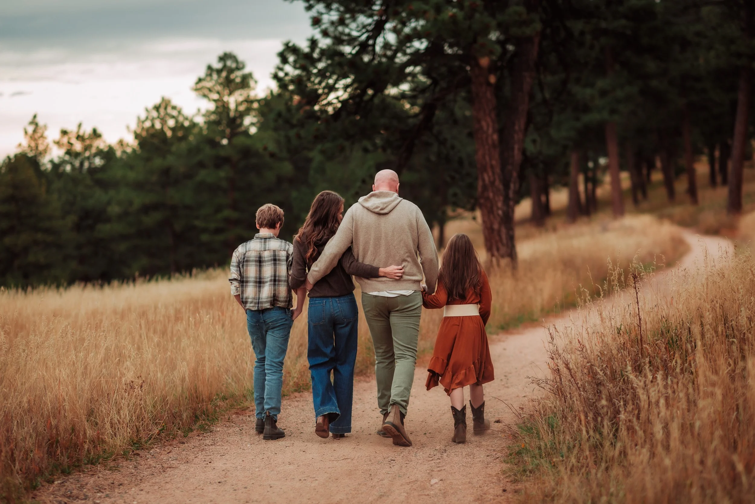 Family of four walking together at Betasso Preserve in Boulder during a fall family photo session
