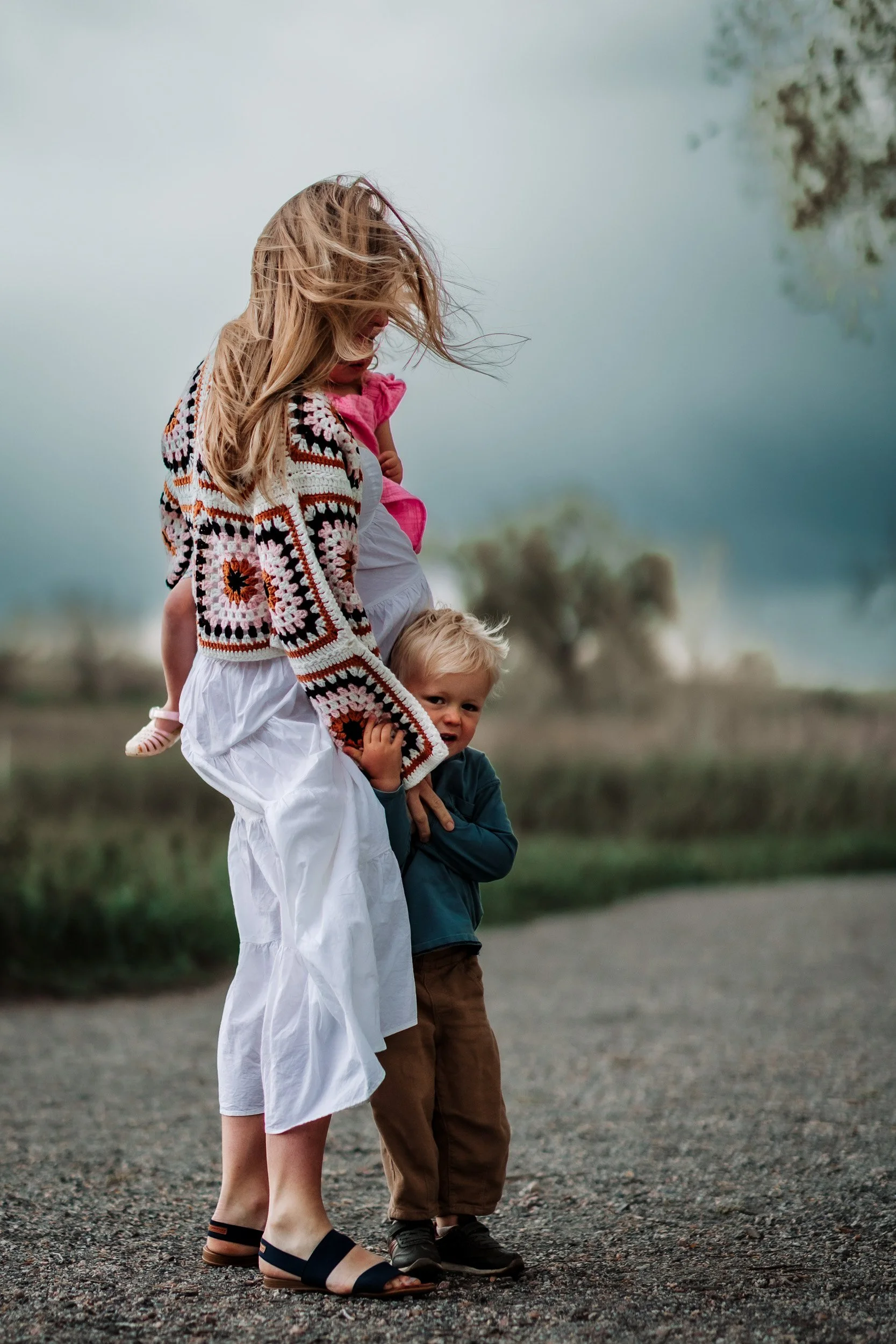 Mother standing with her children at Bobolink Trail during a maternity photo session in Boulder, CO.