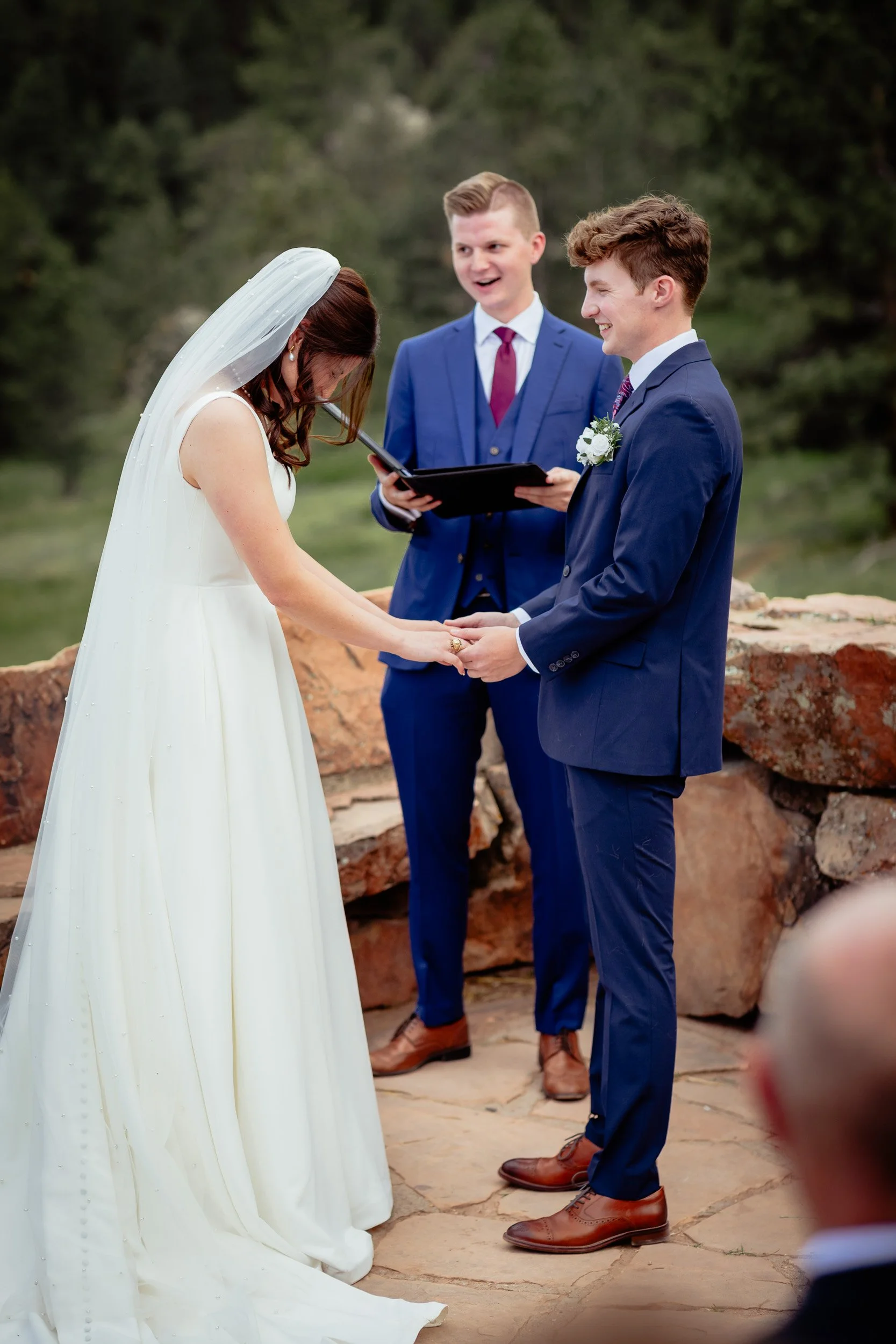 Sam and Grace exchanging vows during their outdoor wedding in the Boulder mountains