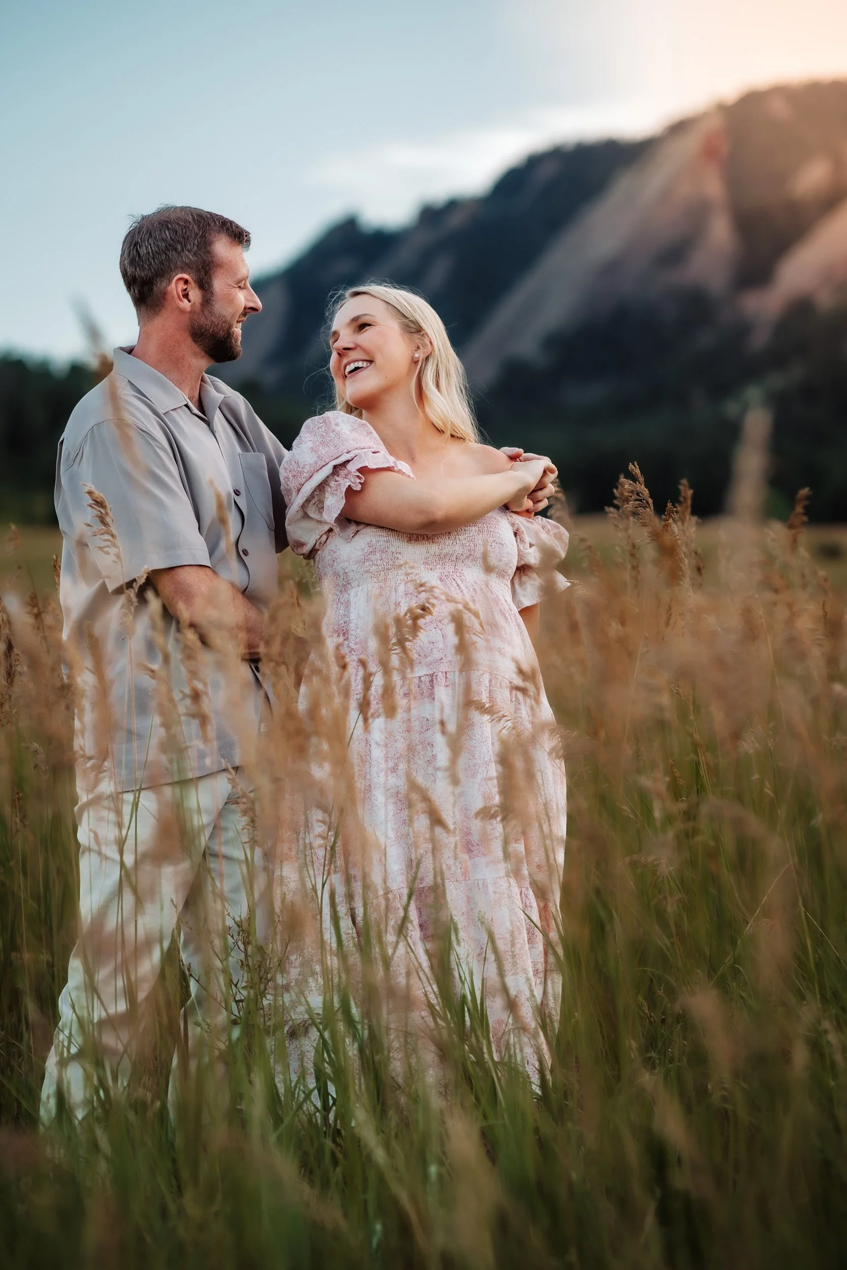 Pekabu twirling in her feminine dress while David watches lovingly during golden hour