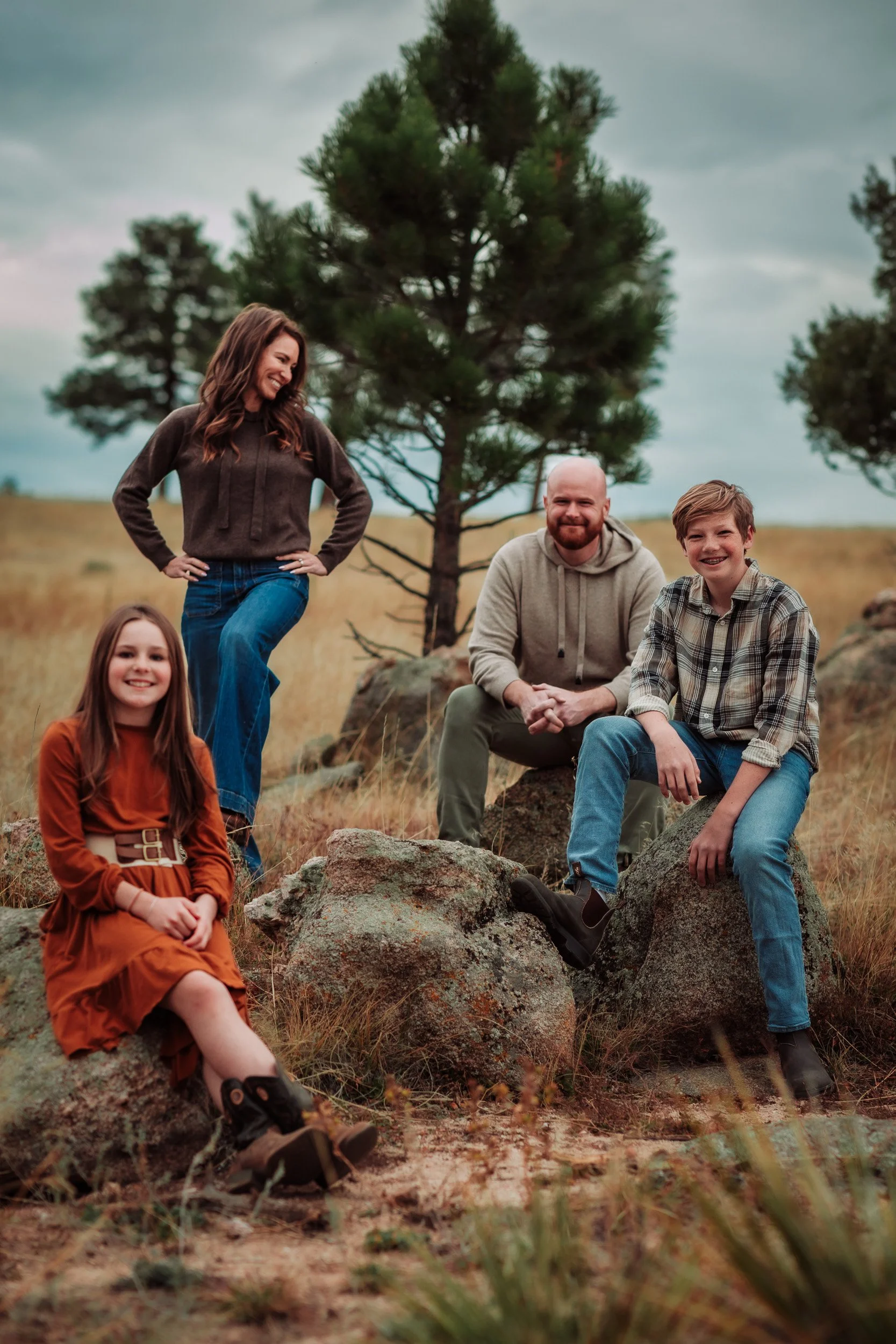 Relaxed family portraits with pine trees and soft backlighting at Betasso Preserve