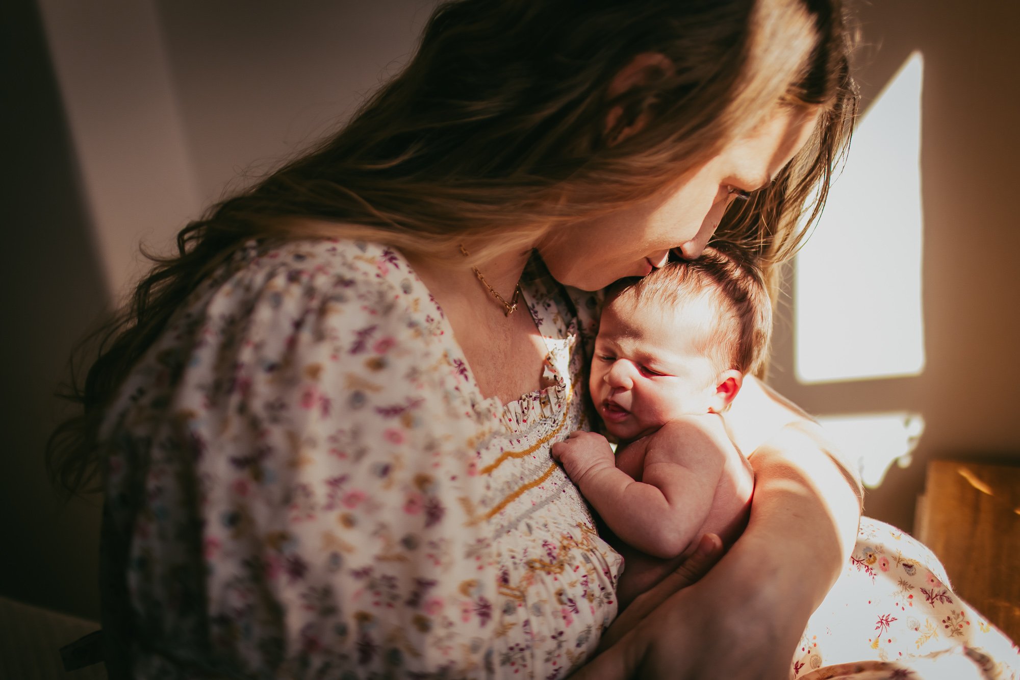 Woman holding a crying baby.