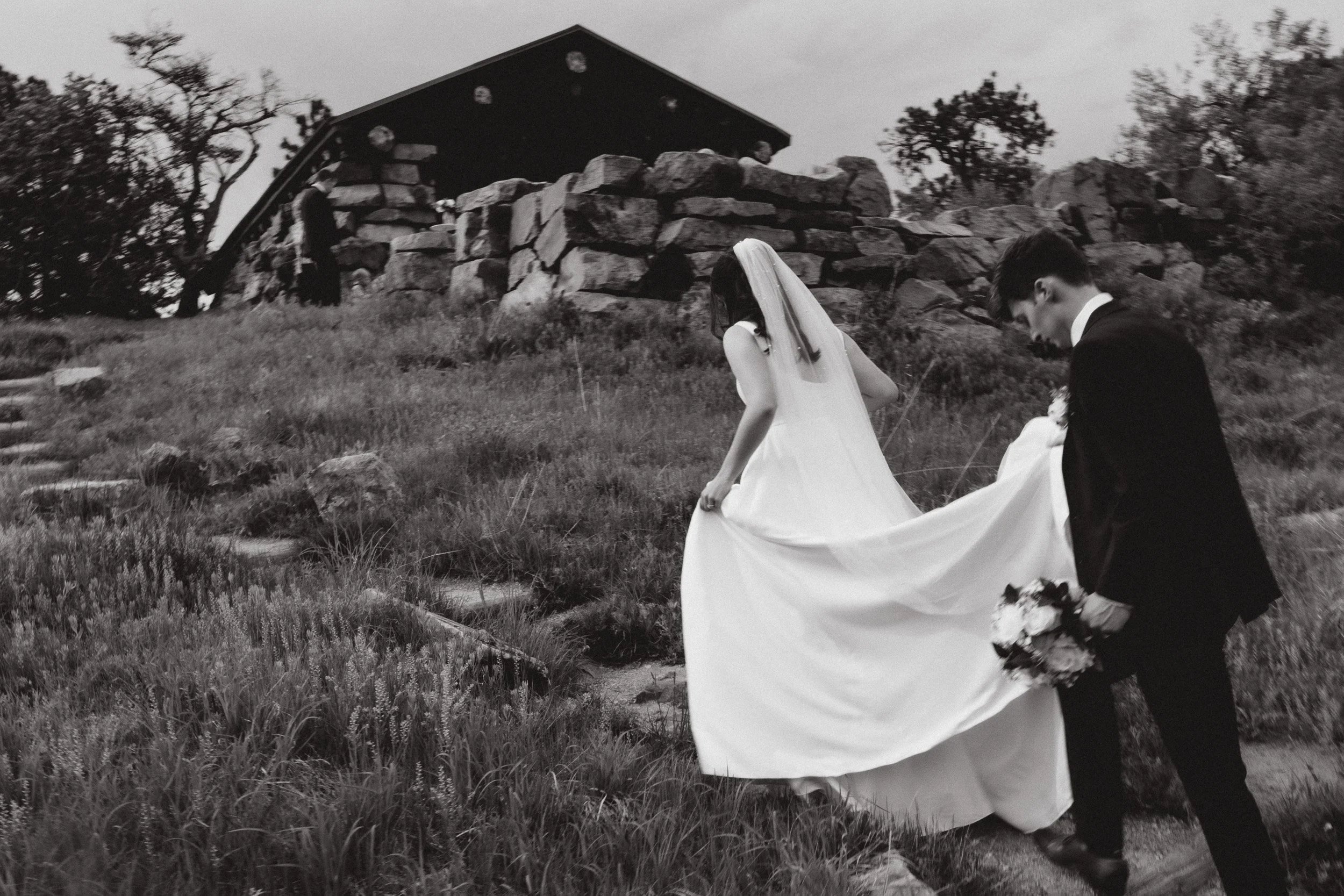 Newly married couple walking together at Halfway House on a cloudy May afternoon