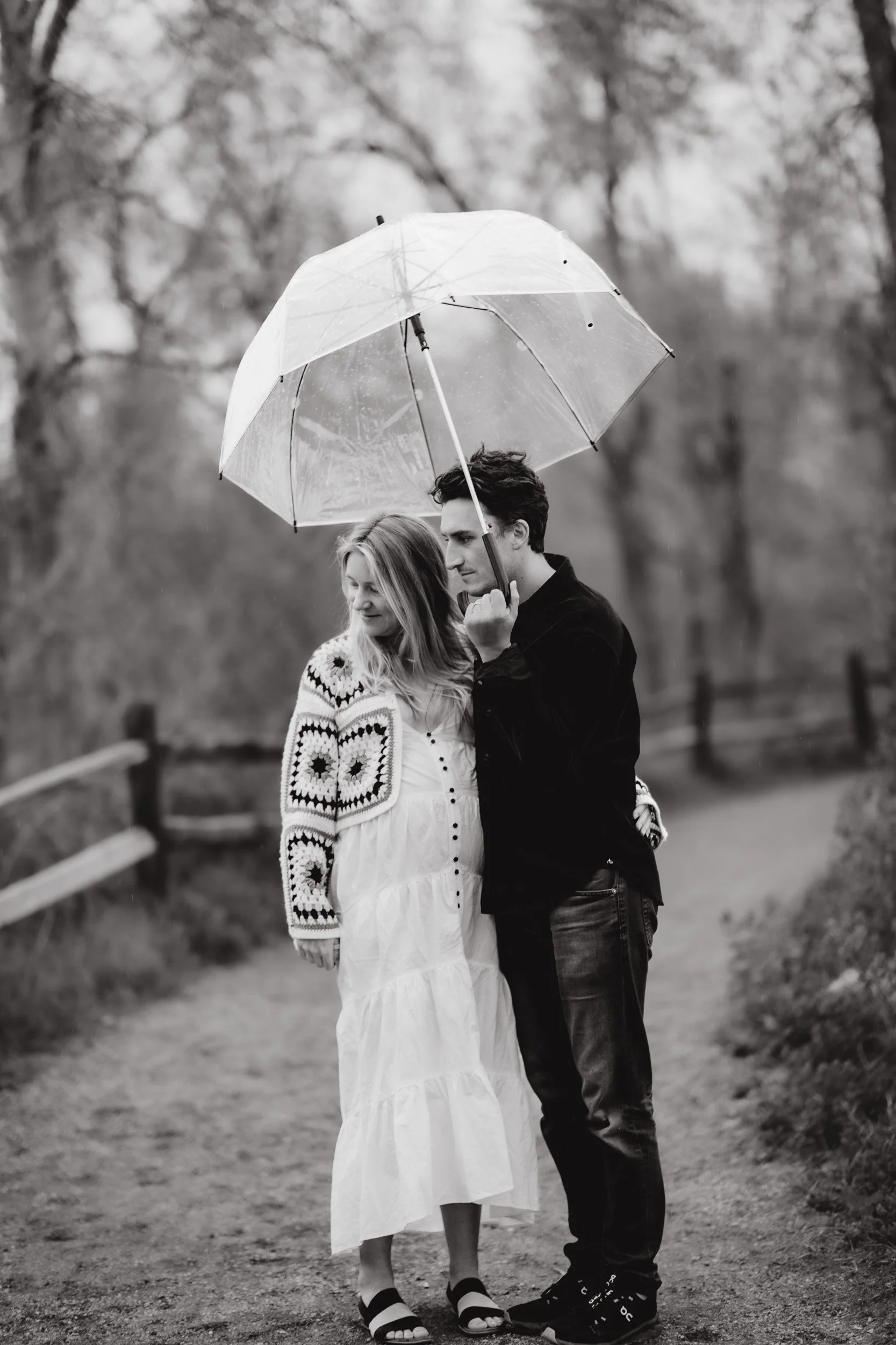 Family maternity photo with dark storm clouds at Bobolink Trail in Boulder, Colorado