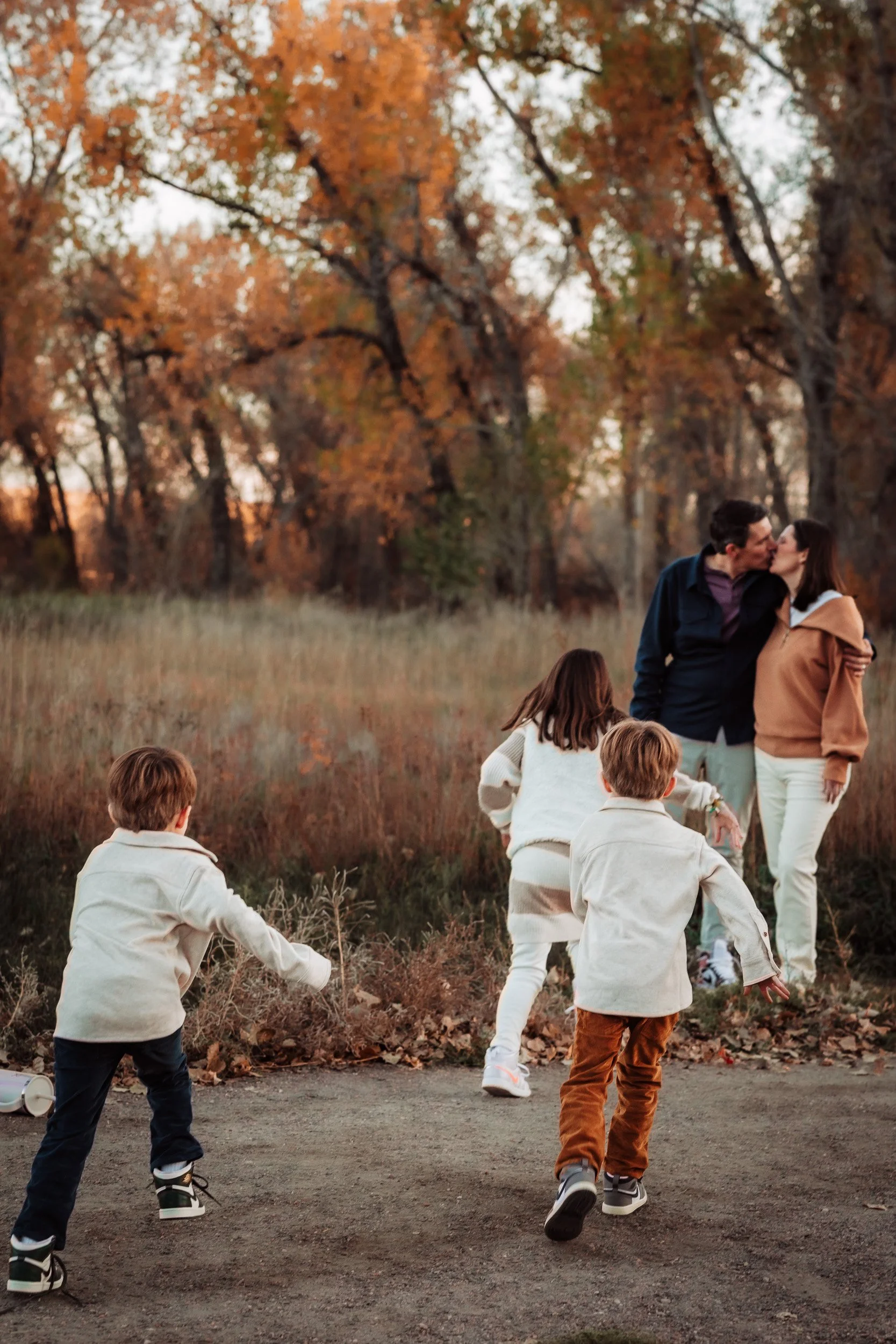 Fall family session with parents and three children walking along Bobolink Trail in Boulder, Colorado