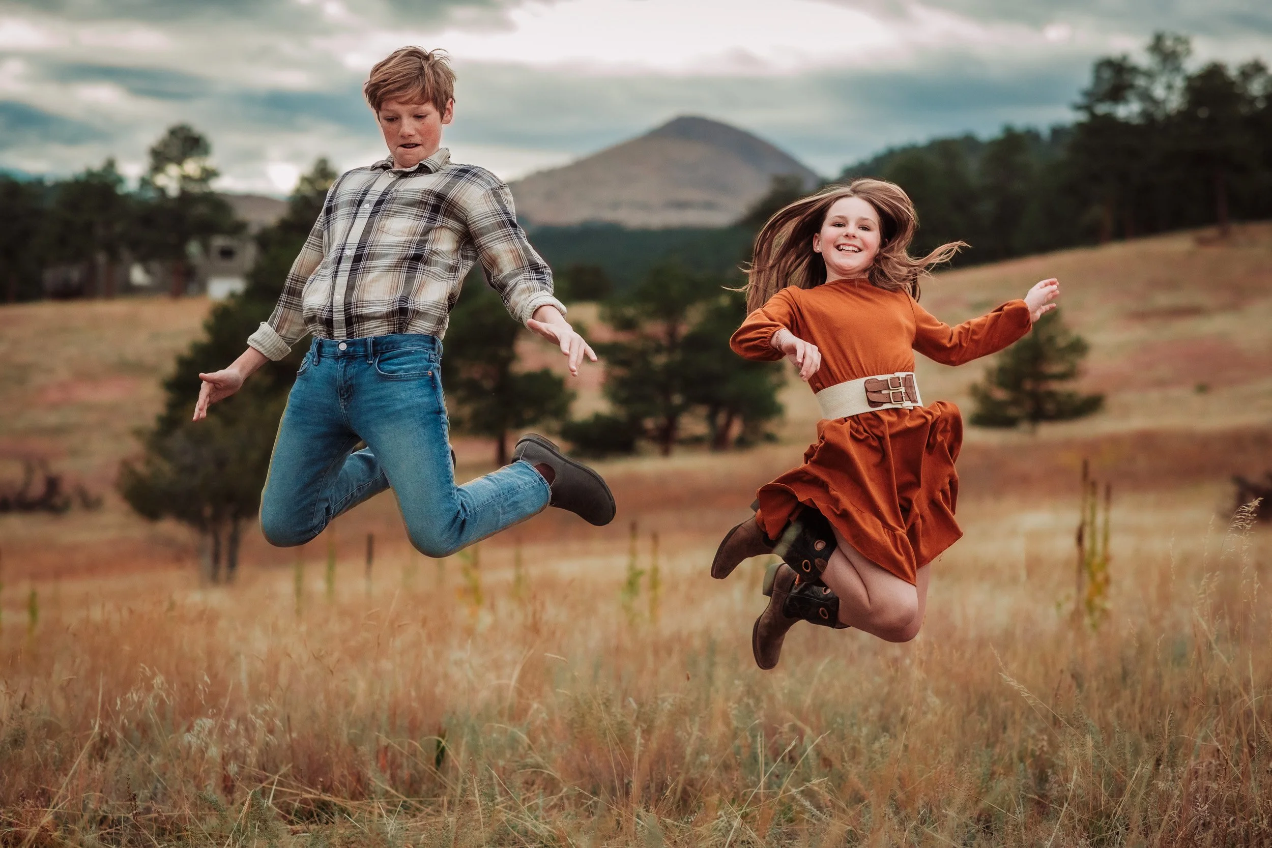 Boulder family session with neutral and warm-toned outfits in a natural forest setting