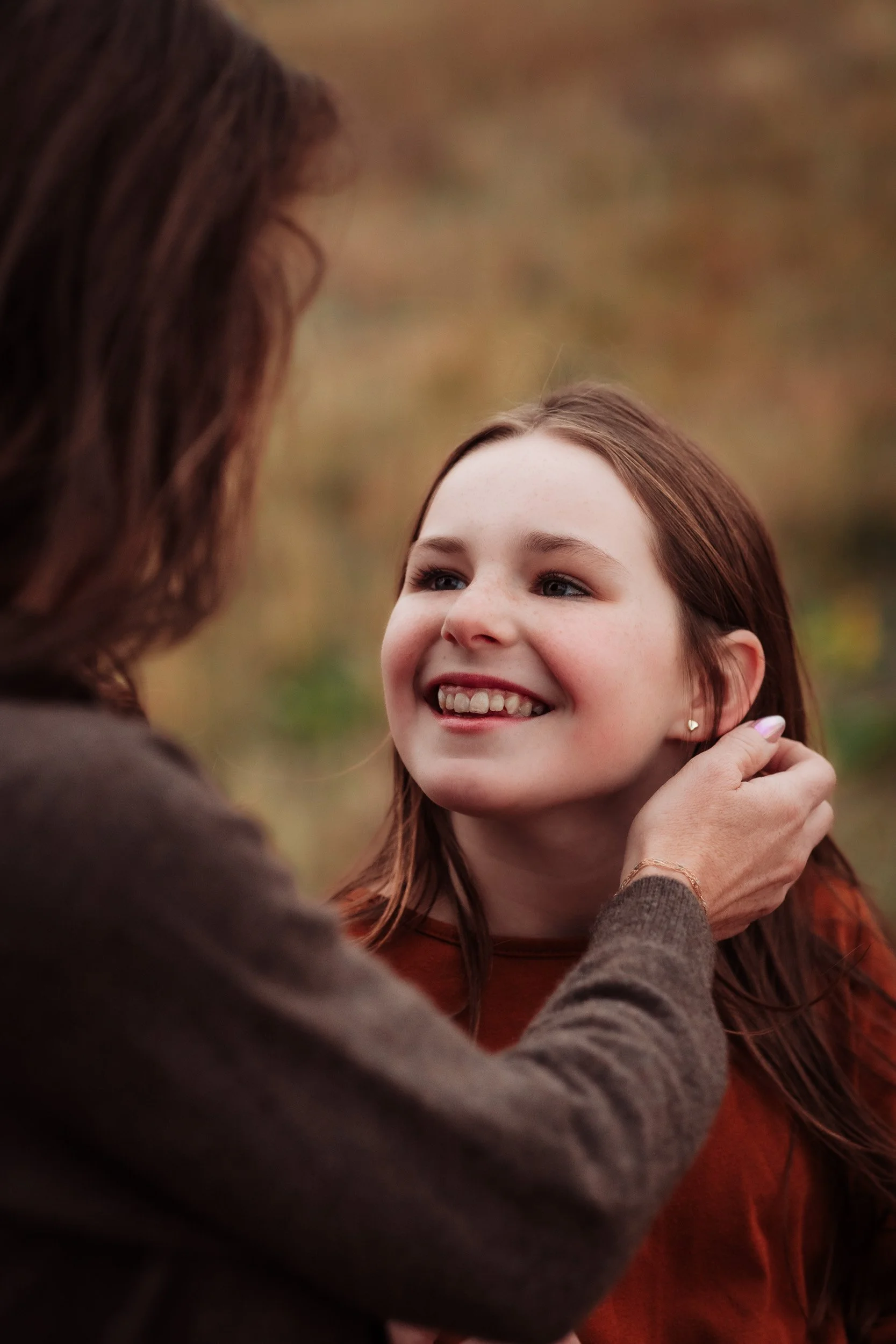 Mother and daughter sharing a quiet moment during a fall family photography session in Boulder