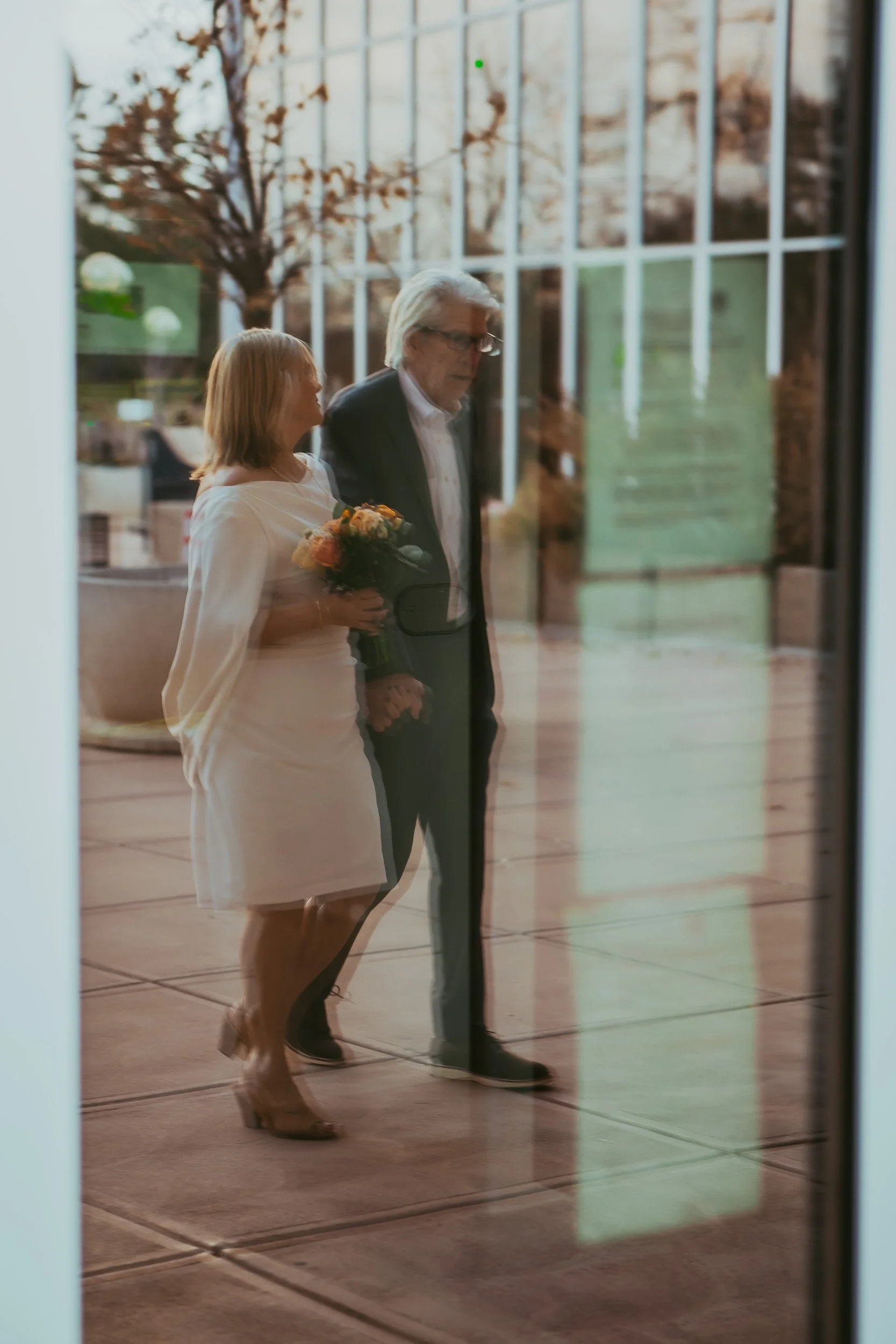 Mark and Laurie walking into courthouse about to get married