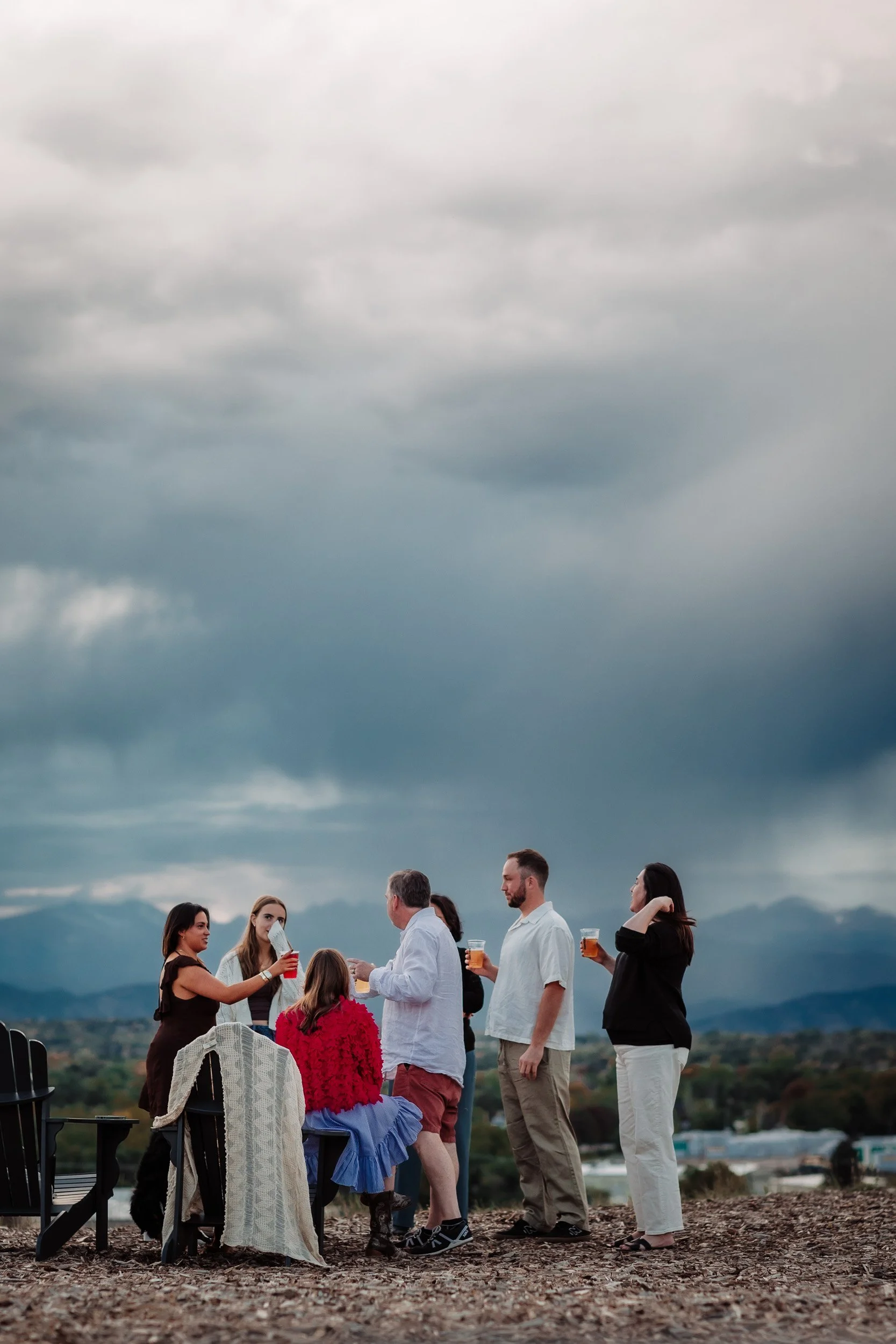 Family celebrating Adam and Gaby’s engagement outdoors at Acreage Brewery
