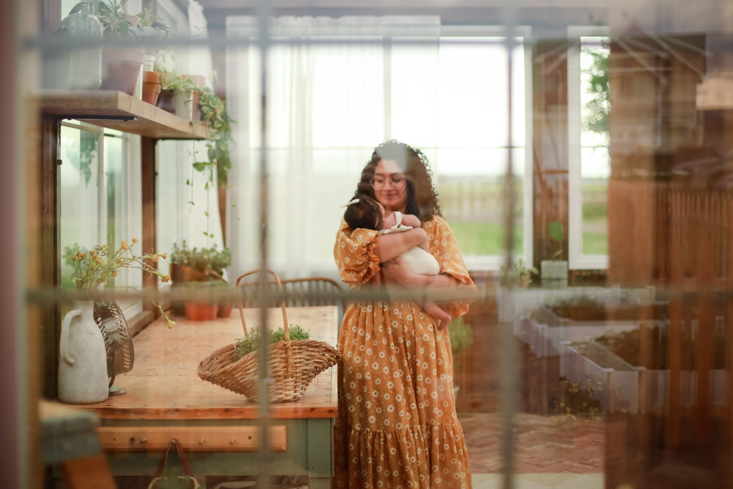 A whimsical family photoshoot at a charming greenhouse in Windsor, CO, during golden hour. This session beautifully blended warm, glowing light with lush greenery, capturing tender connections and playful moments—ideal for families who love unique, n