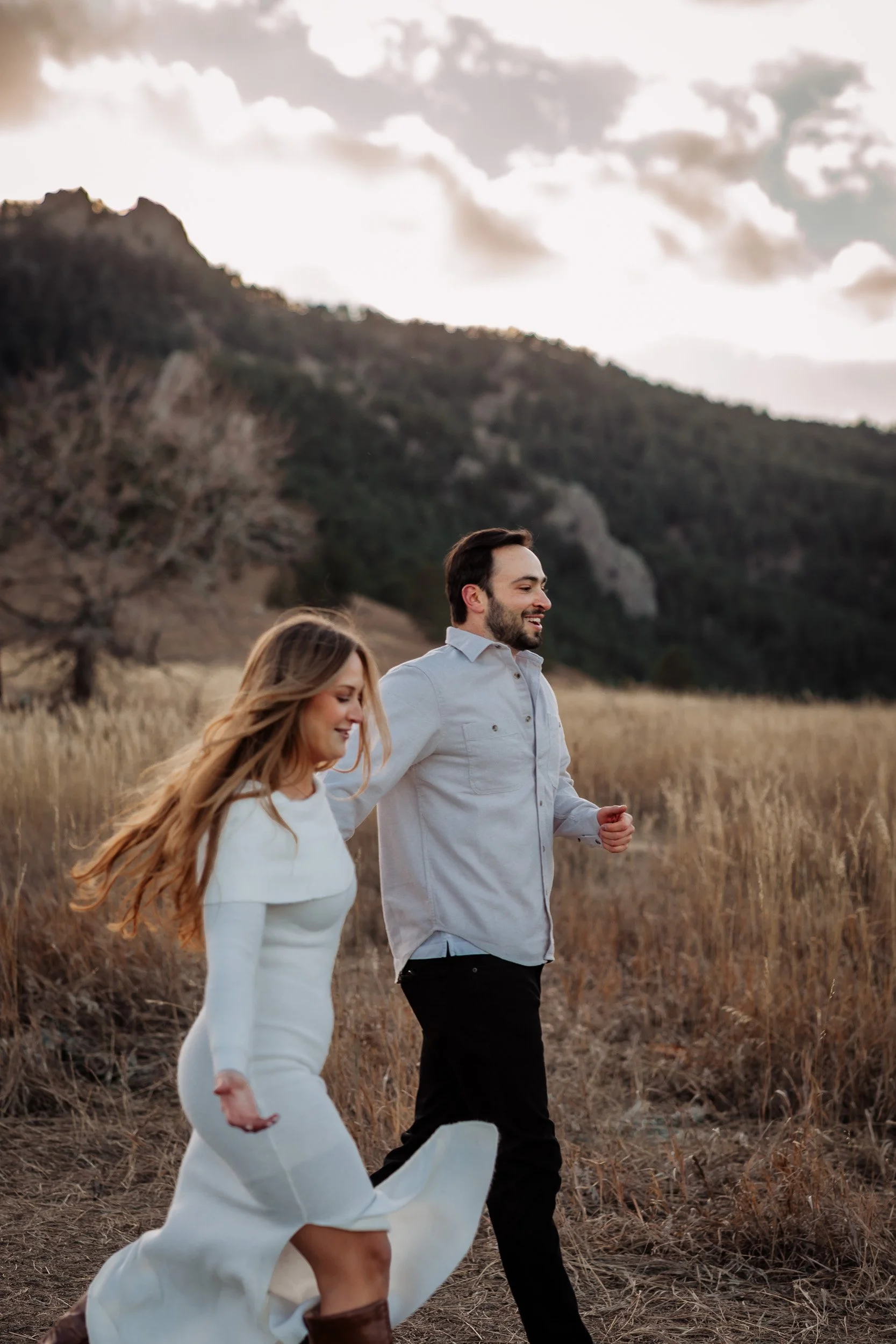 Couple walking together at Chautauqua Park during late fall engagement session in Boulder, Colorado