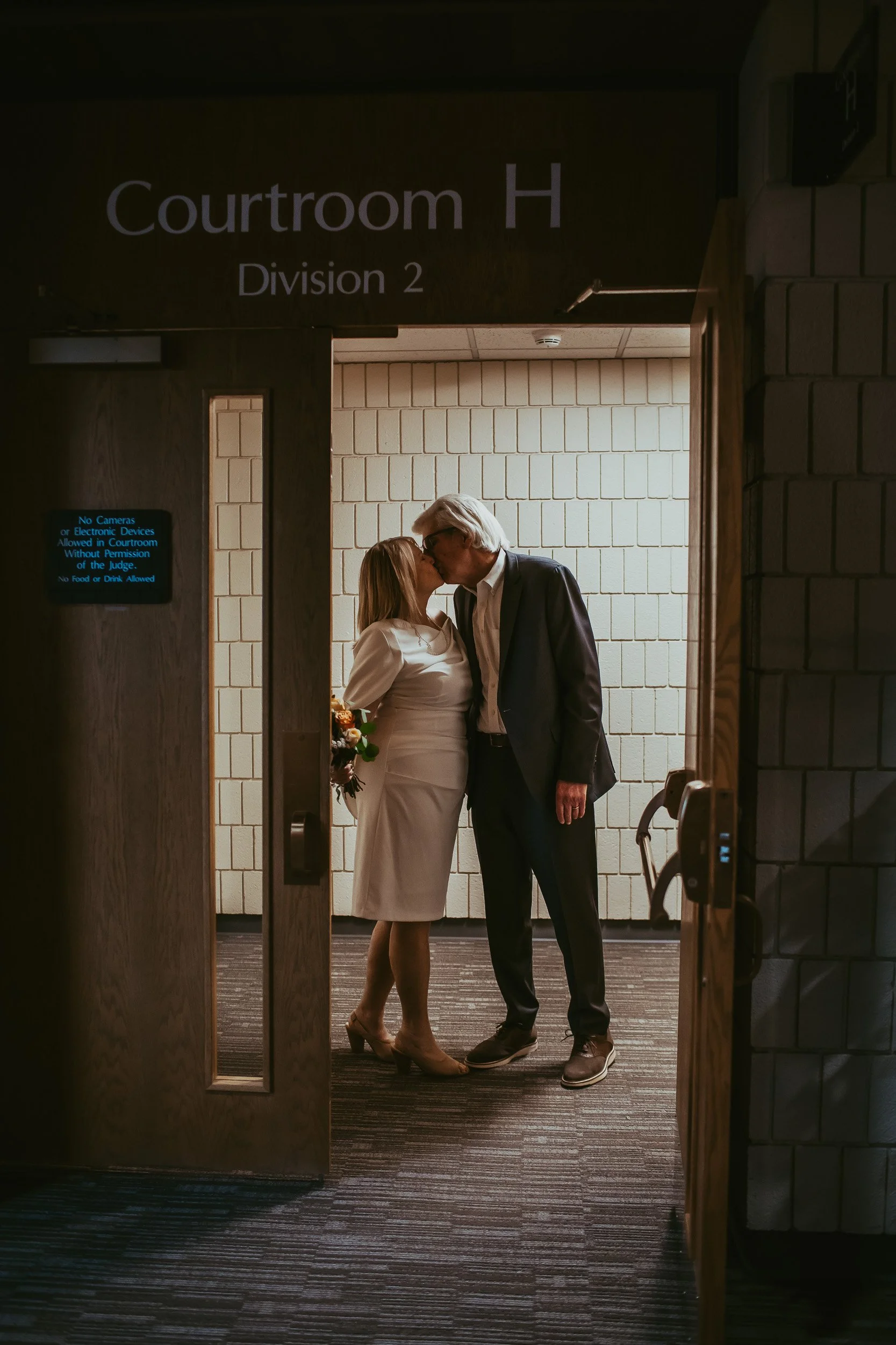 Laurie and Mark kissing after their courthouse wedding ceremony at Boulder Municipal Court
