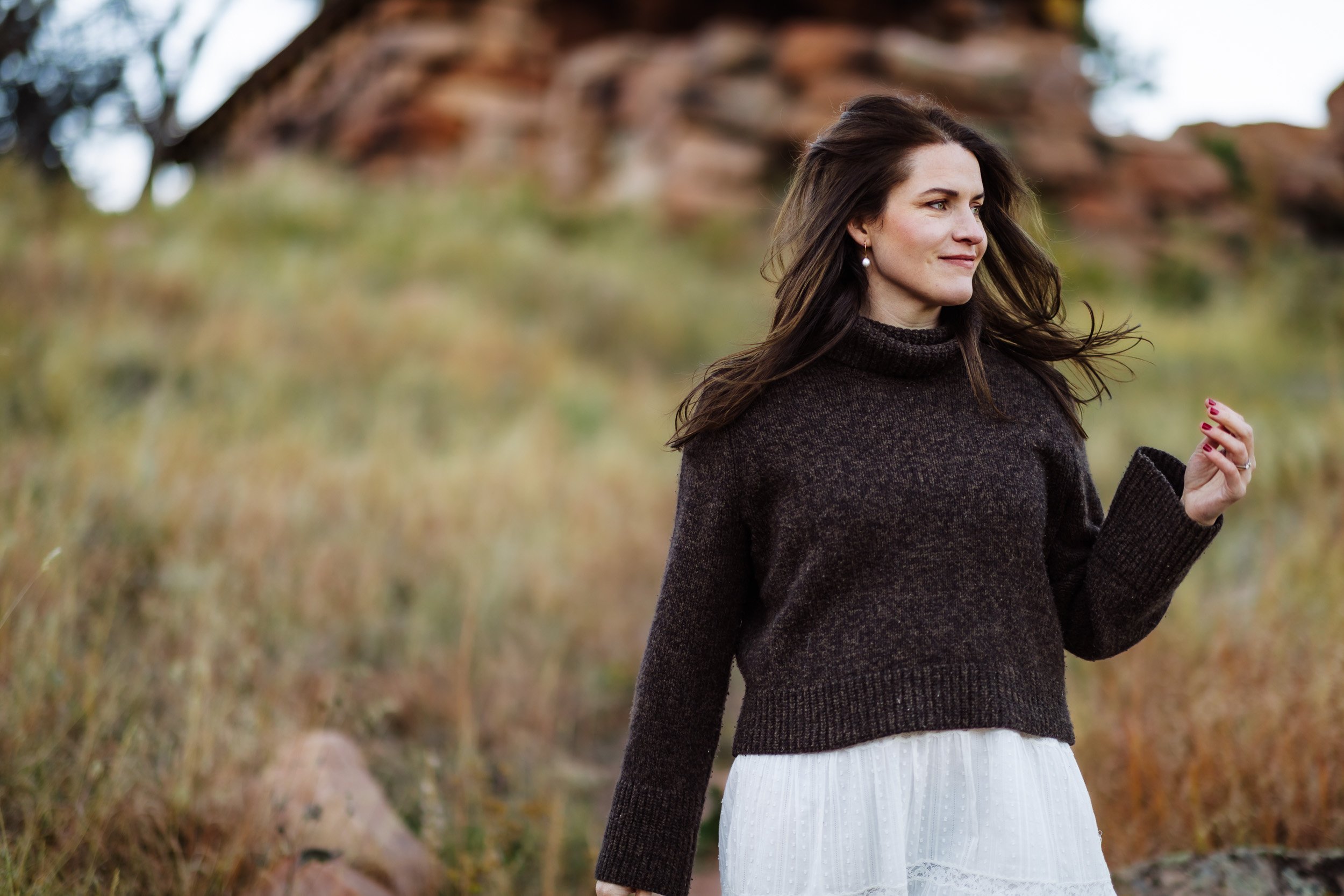 Woman walking along trail during branding photo session in Boulder foothills