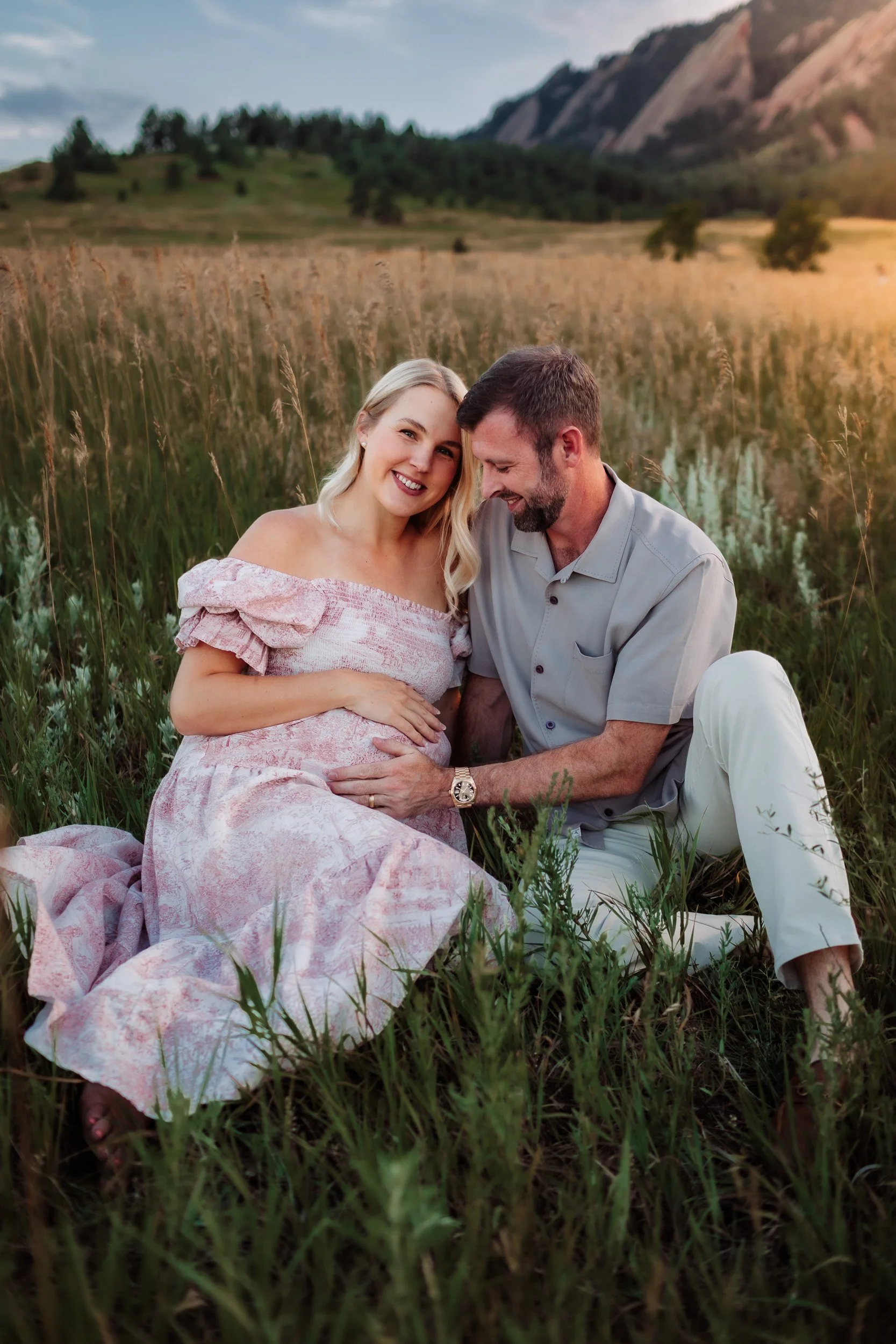 Intimate moment of Pekabu and David embracing in the grassy fields of Boulder, CO