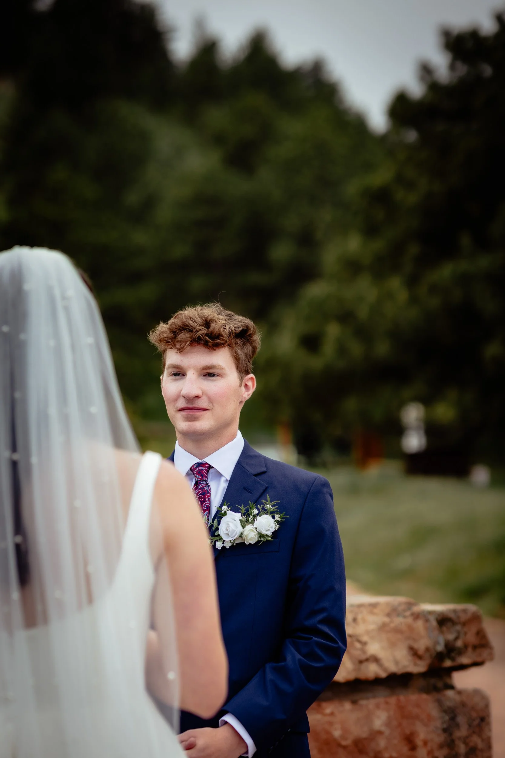 Sam and Grace exchanging vows during their outdoor wedding in the Boulder mountains