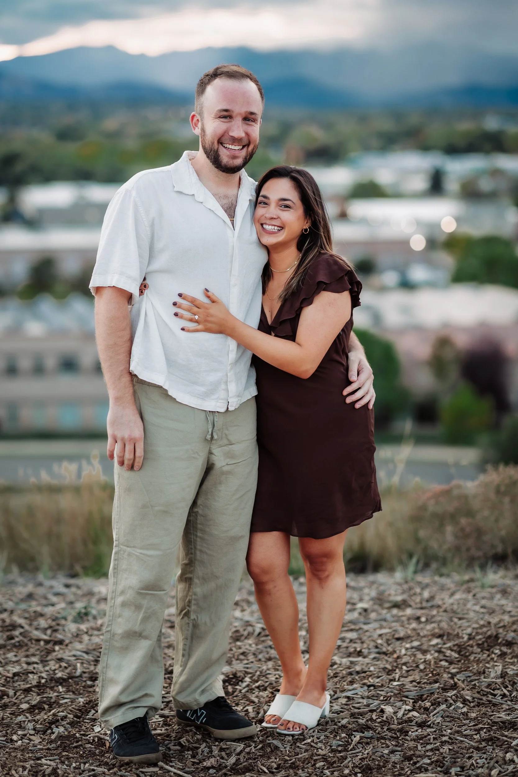 Couple embracing after a proposal at Acreage Brewery in Lafayette, CO