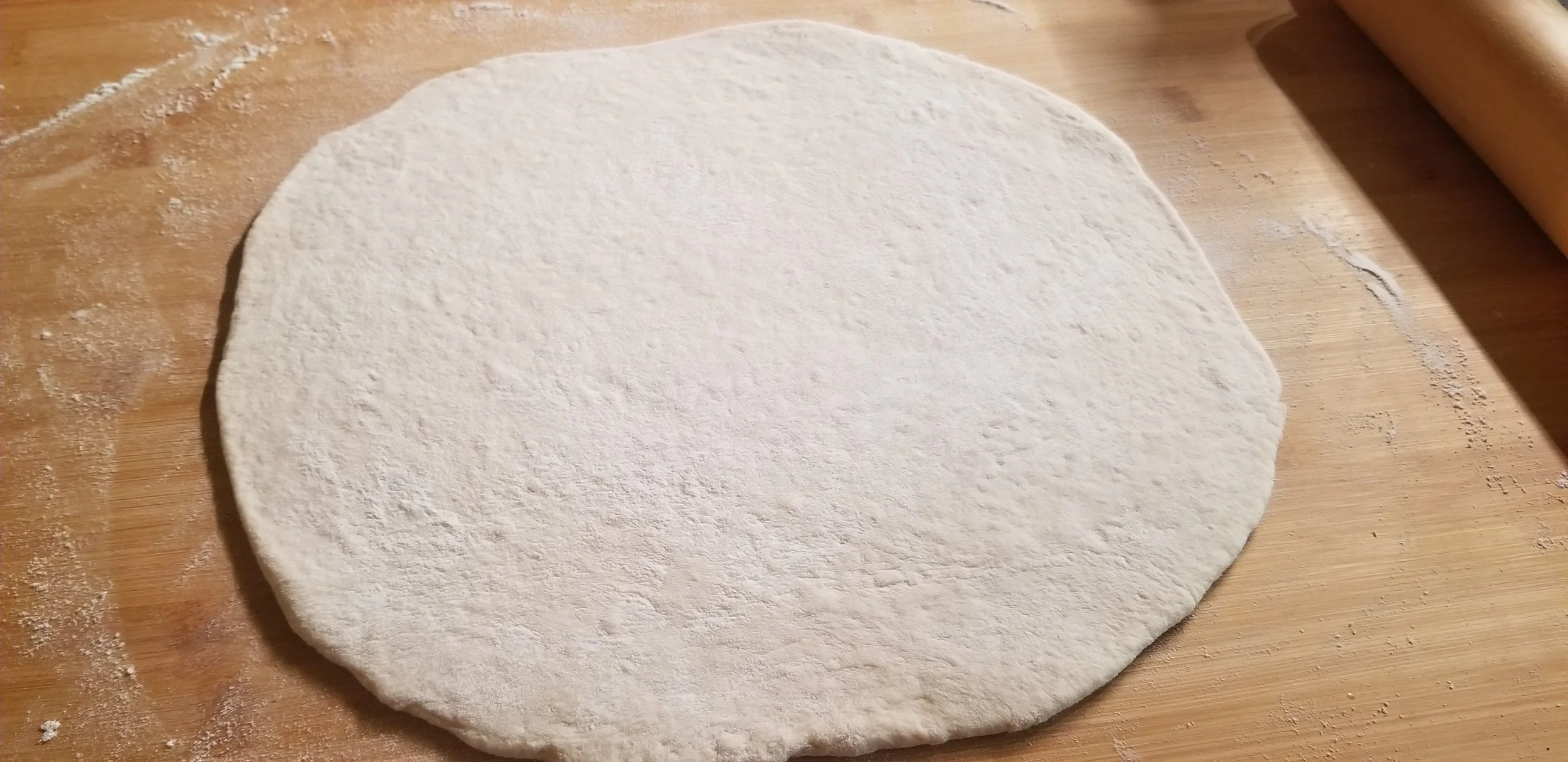 rolled out pizza dough