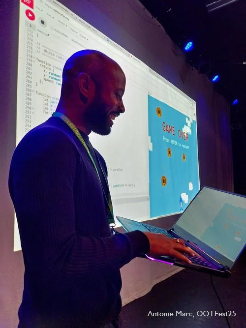 Antoine Marc demonstrating a computer game during a Playful AI session at OOTFest25