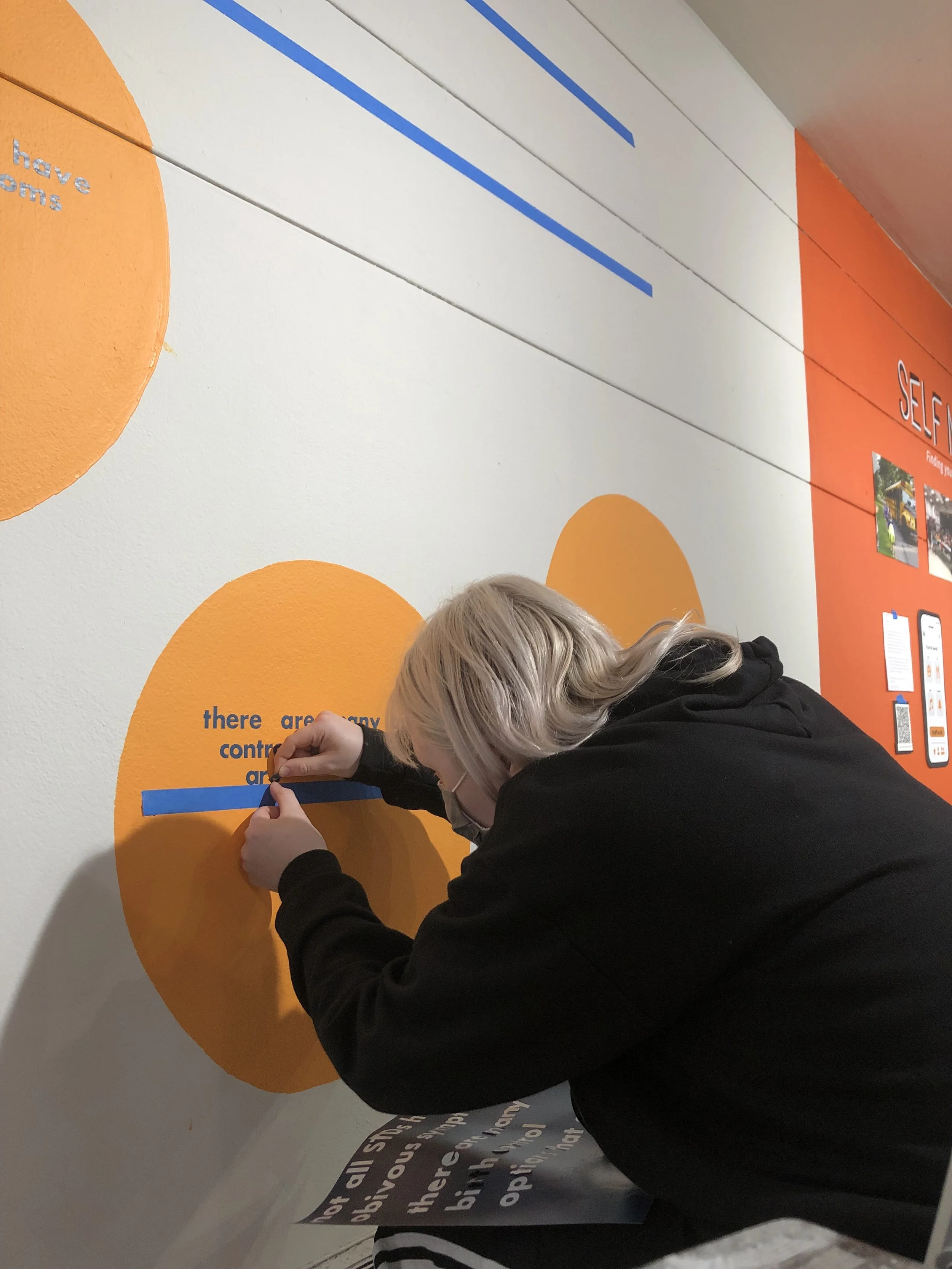 woman sticking on vinyl lettering
