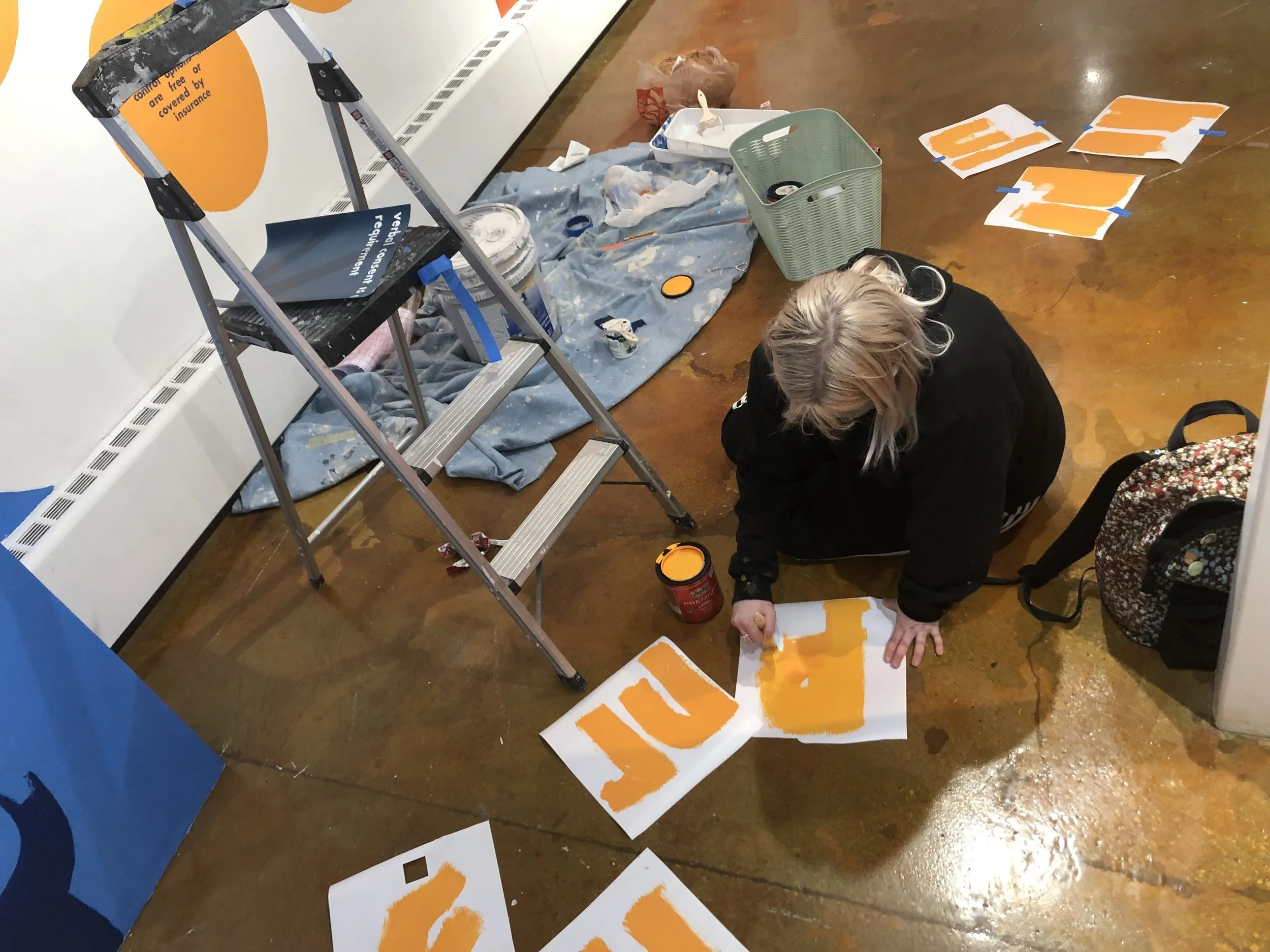 woman painting on the floor