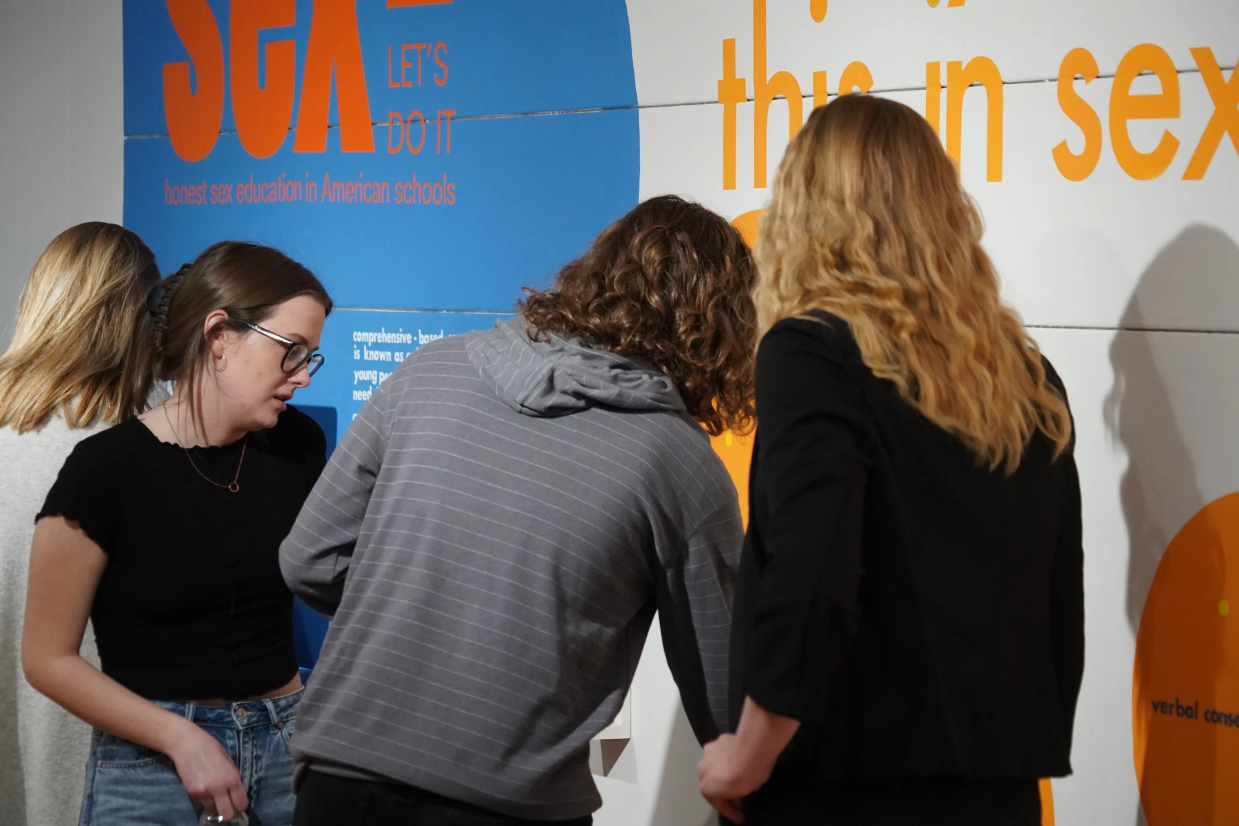 group of people interacting with an art installation
